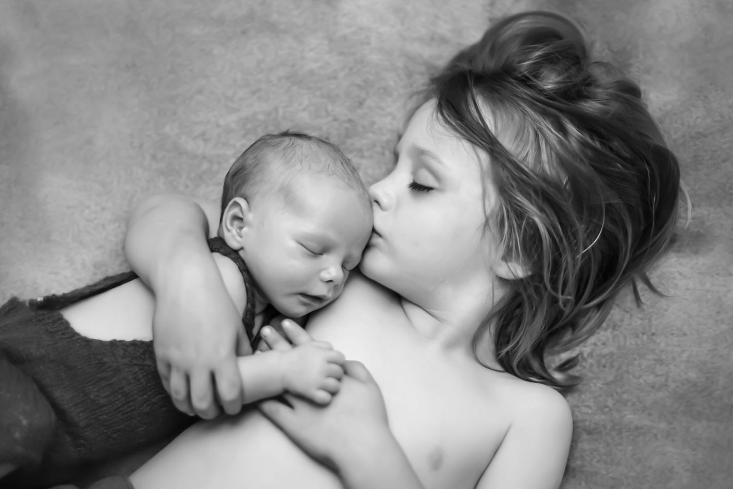 A tender black and white photo series showing intimate moments between a mother and baby.