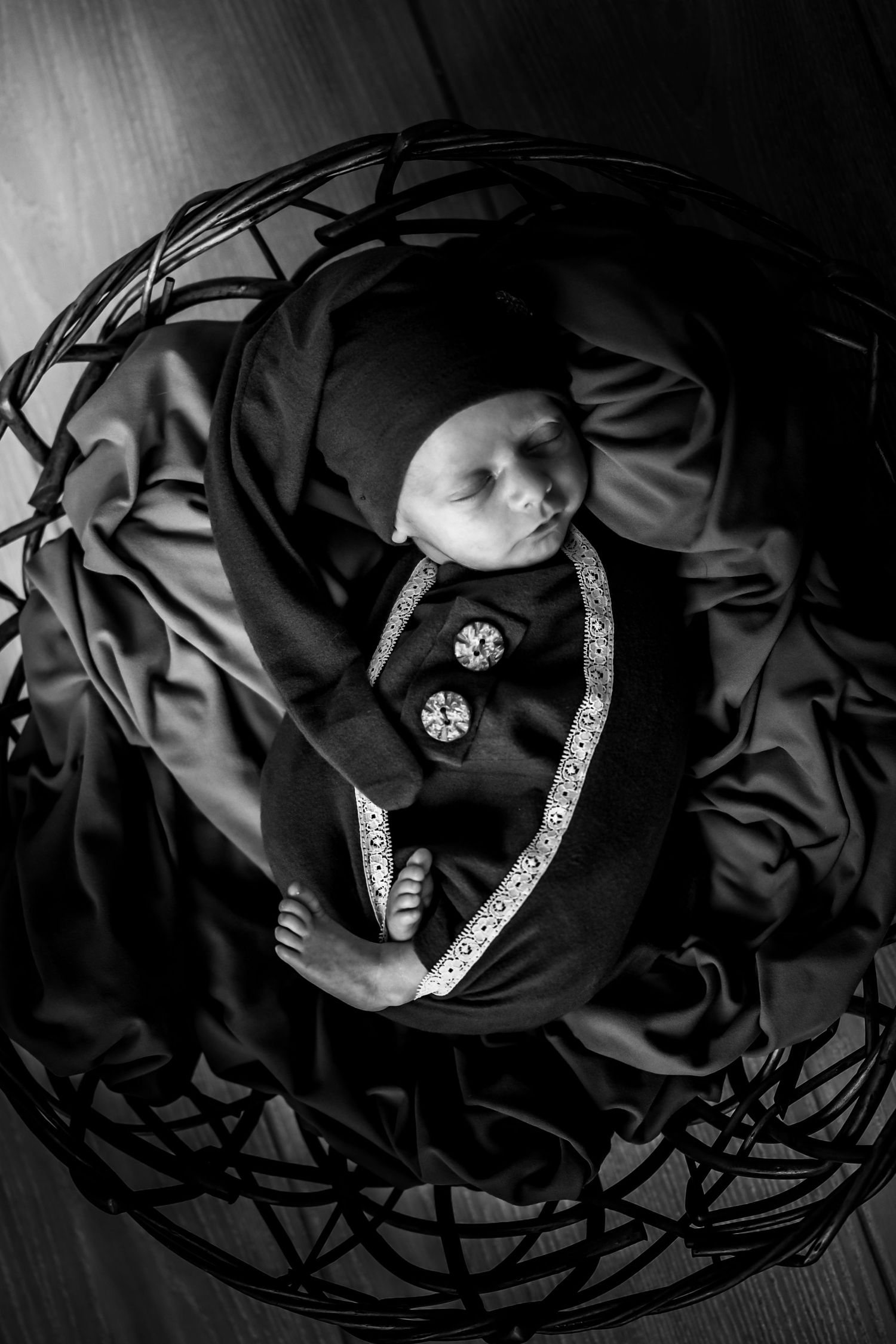 Black and white artistic photo series showing a diamond ring nestled in dark silk fabric from different angles.