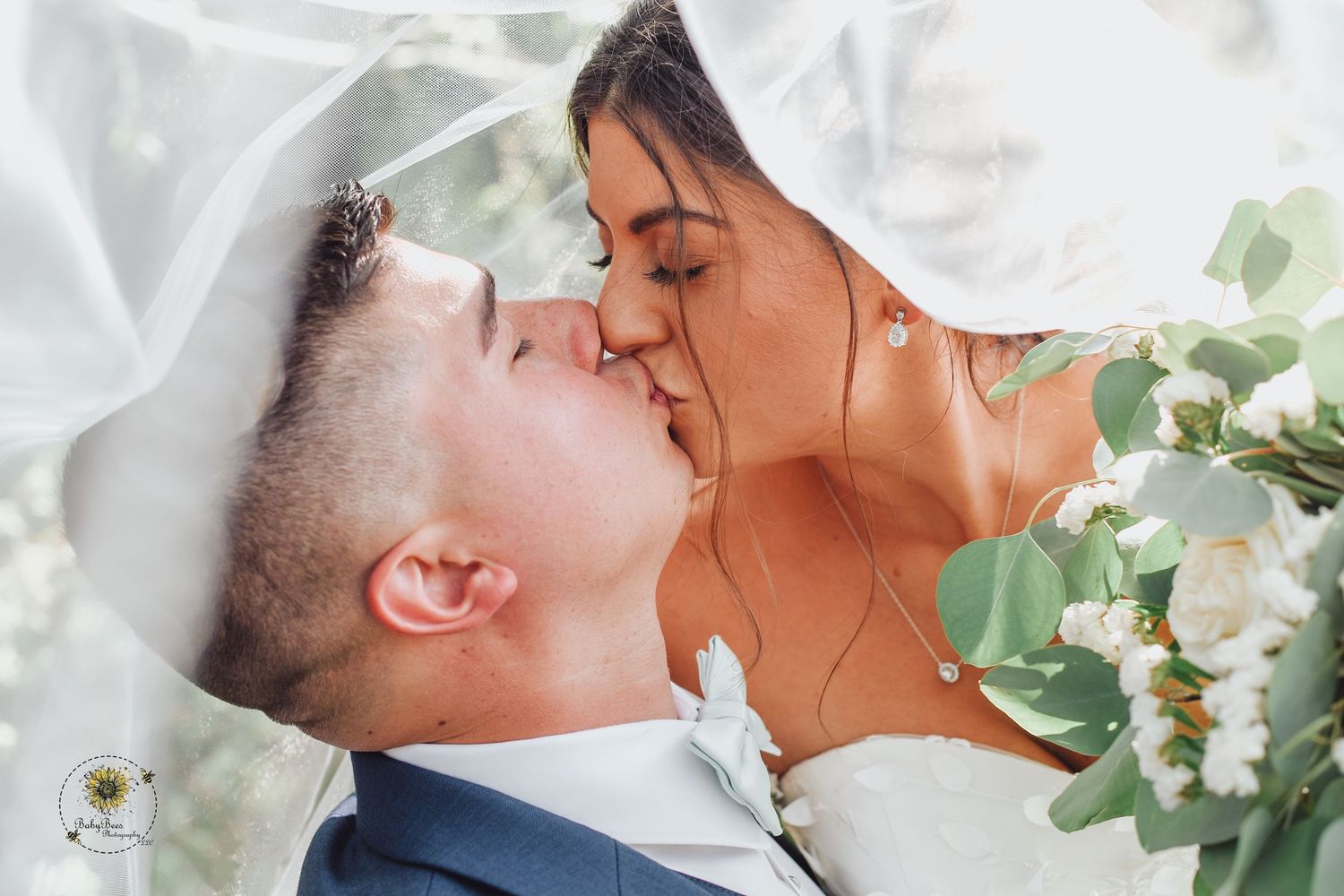 Romantic wedding portraits with eucalyptus and floral arrangements.