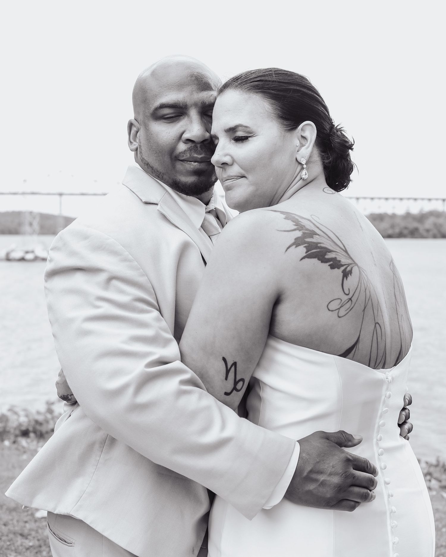Romantic black and white portraits of couple embracing outdoors.