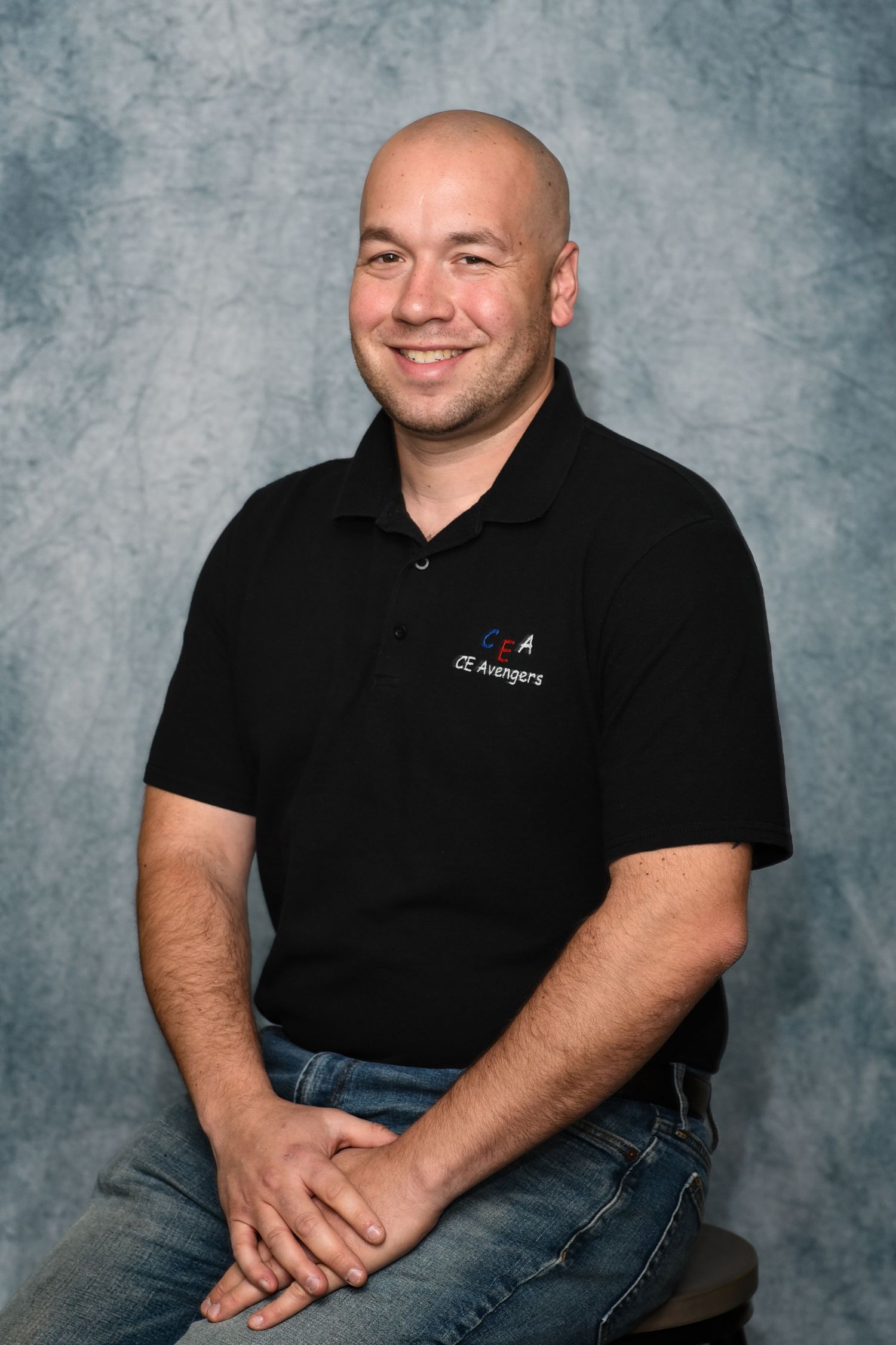 Professional studio portrait series showing person in black polo shirt against textured gray backdrop.