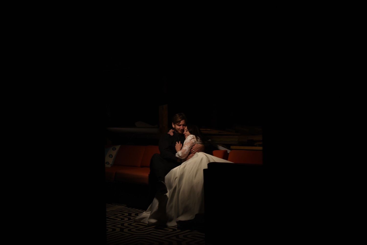 Dark atmospheric performance scene with dramatic lighting and silhouettes.