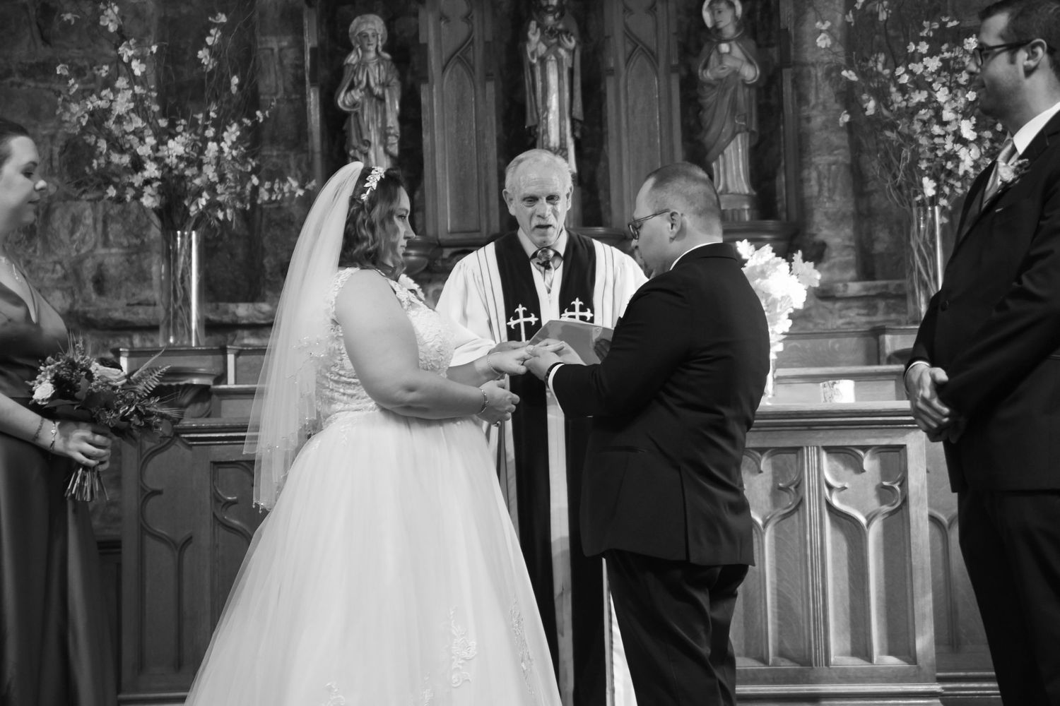 Wedding ceremony participants standing in formal attire during traditional church service.