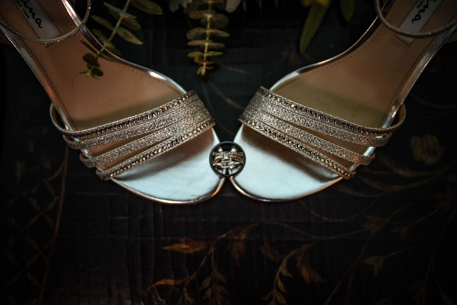 Close-up of sparkly bridal shoes with crystal embellishments.