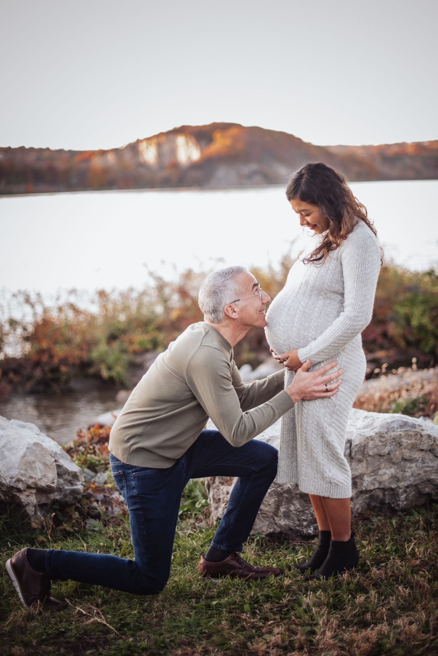 A romantic sunset proposal scene captured in a series of photos on a rocky shoreline at golden hour.