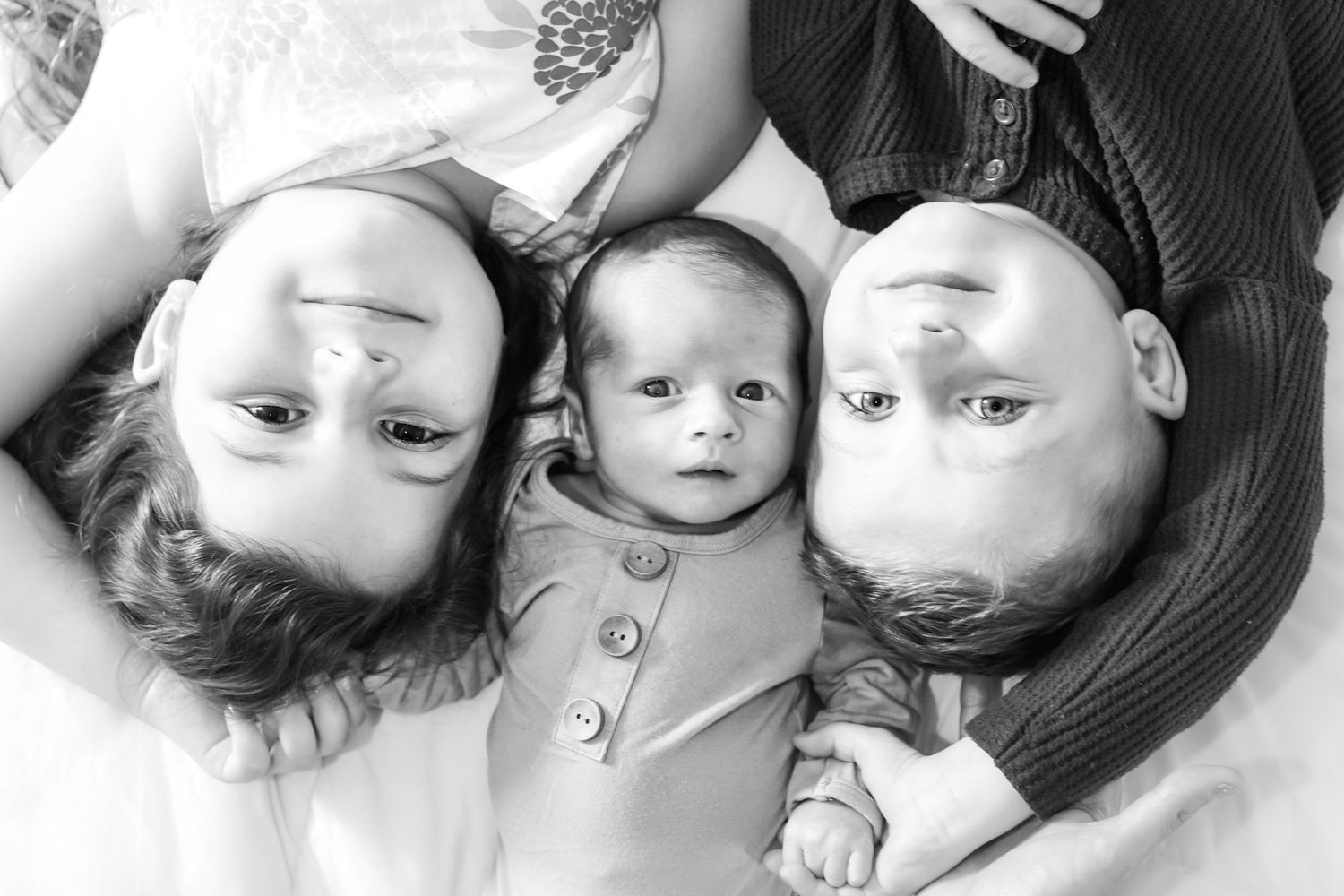 Black and white photo collage showing multiple people lying down and arranged in a circular pattern.