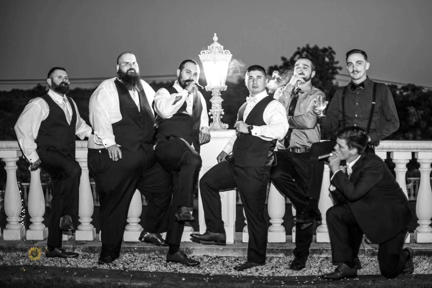 Fun black and white photo sequence of wedding party posing playfully on stairs.