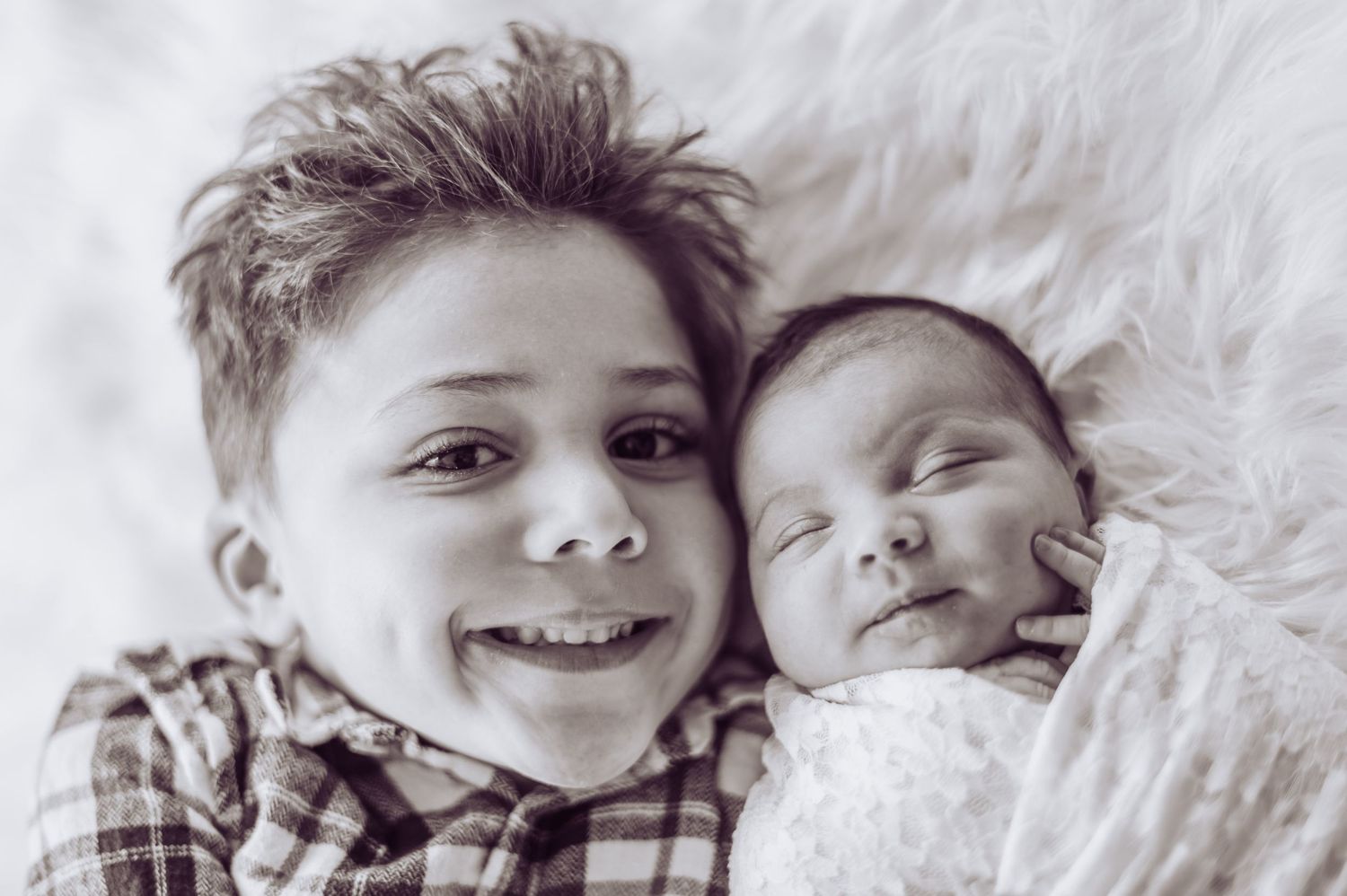 A black and white collage of candid expressions and laughter captured in intimate close-up portraits.