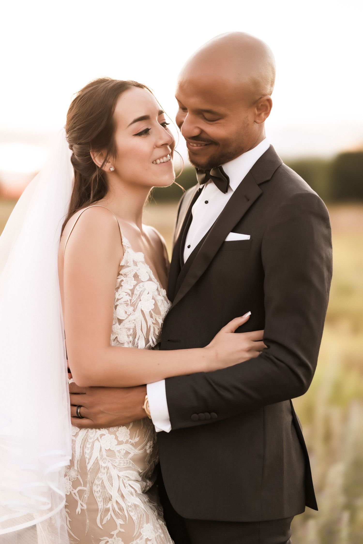 Happy newlyweds share a joyful moment during their outdoor wedding photoshoot.