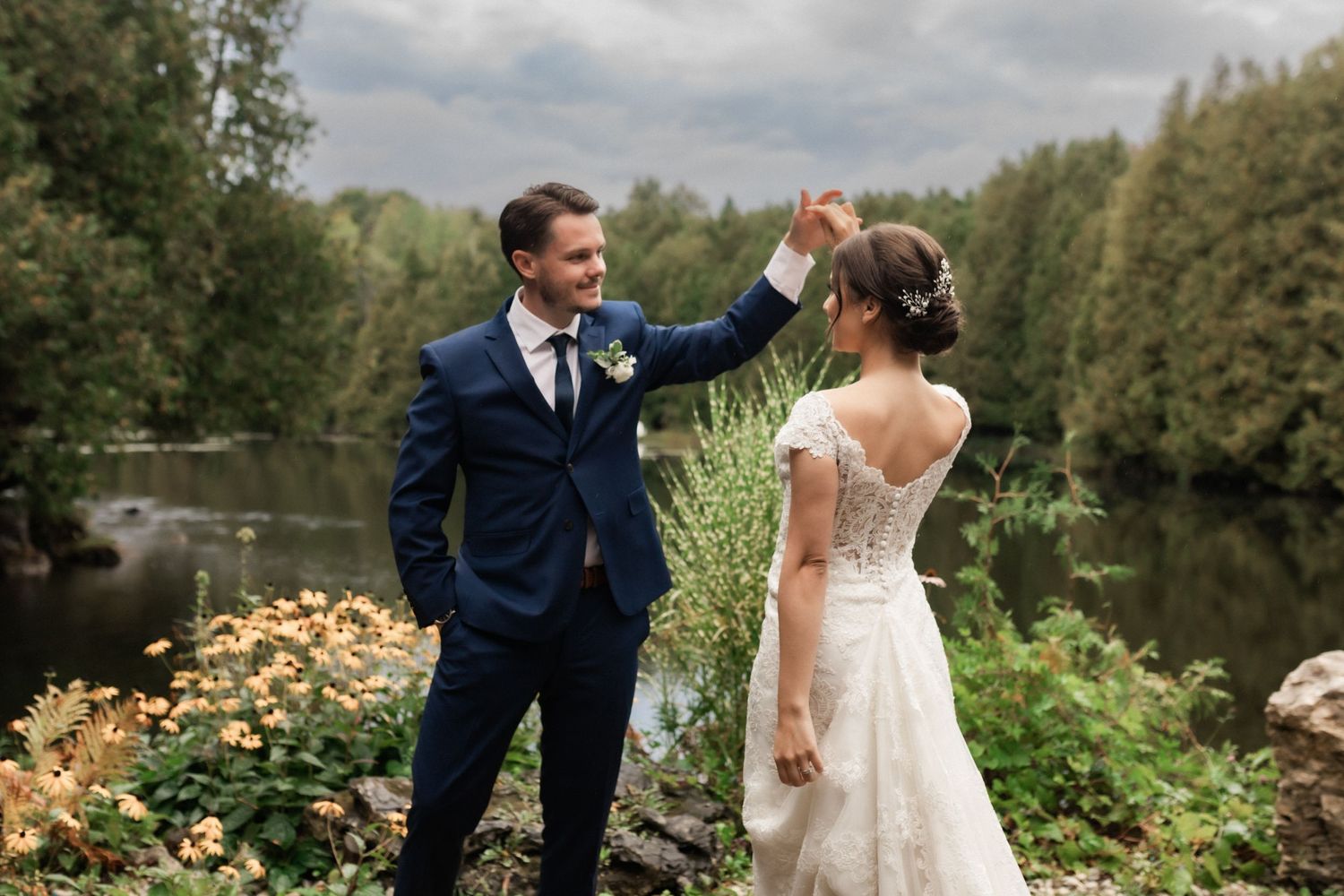Joyful wedding couple sharing a romantic moment in a garden setting.