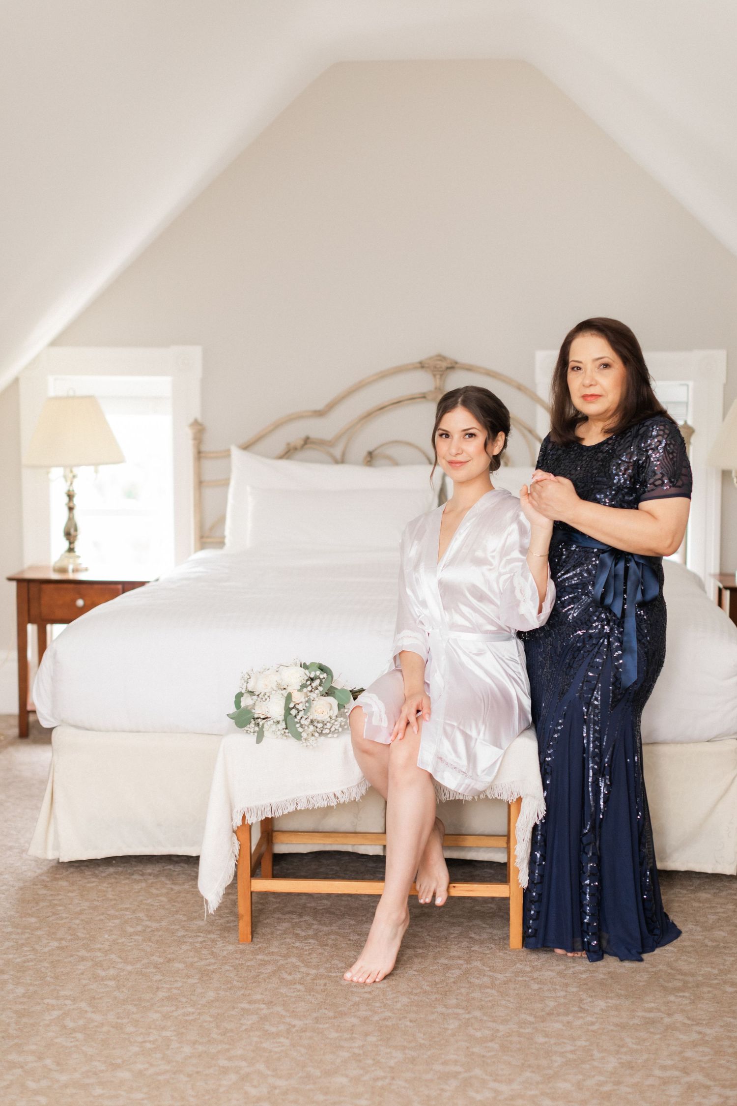Getting ready scene in bright bedroom with elegant formal attire.