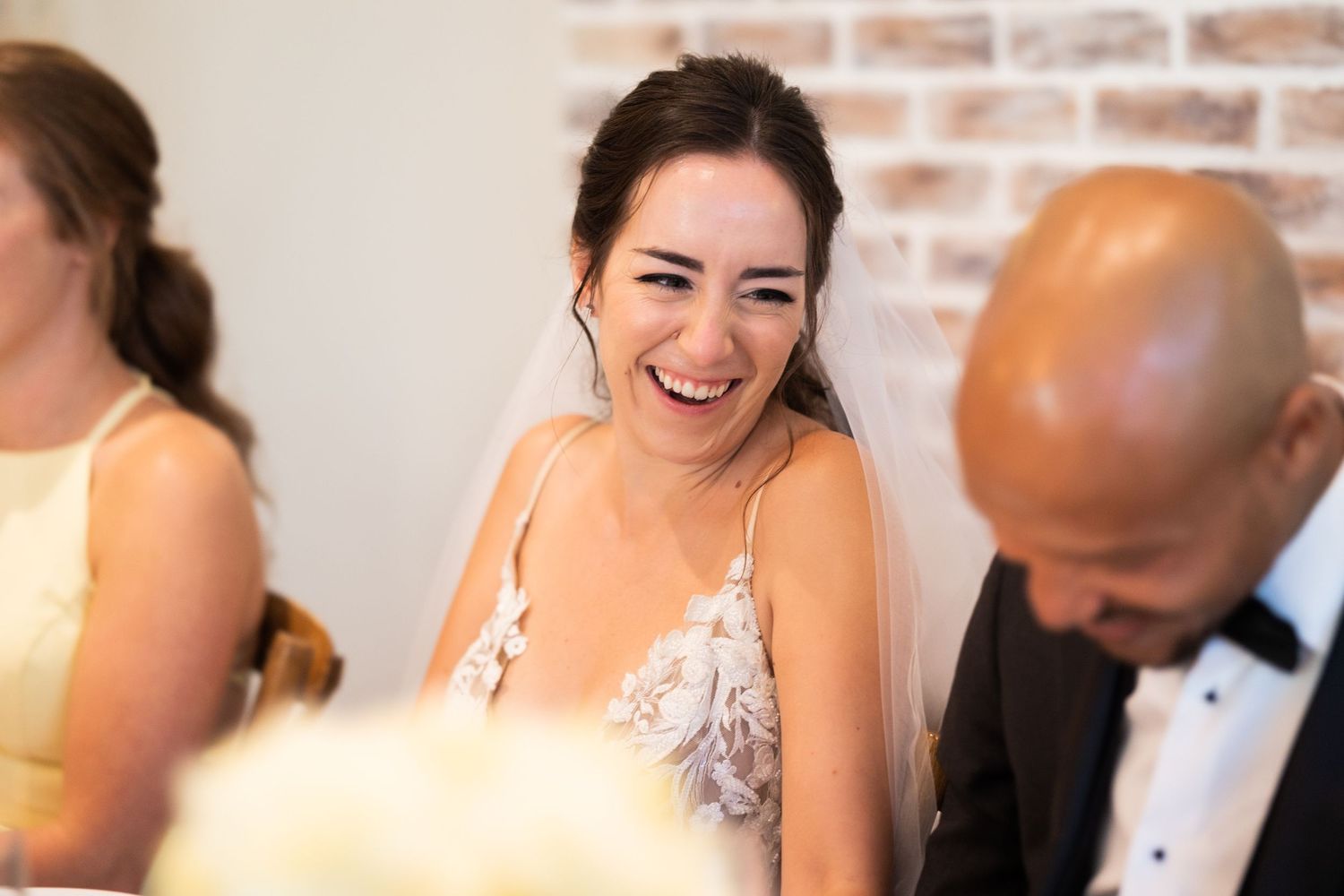 Joyful laughter shared during wedding reception speeches and celebrations.