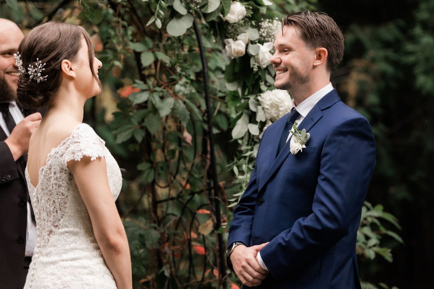 A garden wedding ceremony with delicate lace details and navy blue accents.
