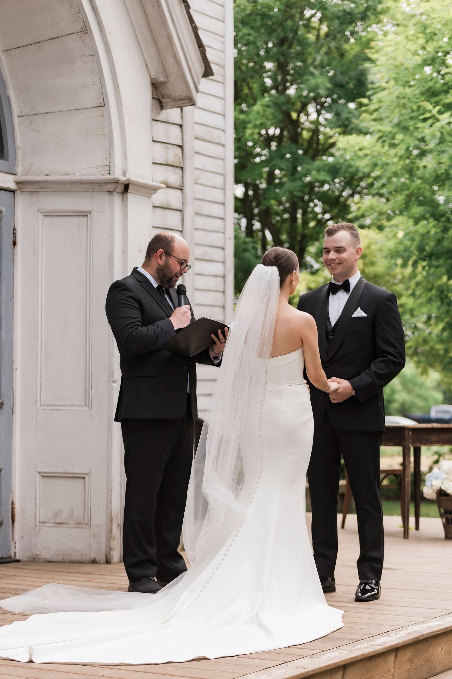 First look wedding reaction captured in a series of four emotional moments on a white porch.