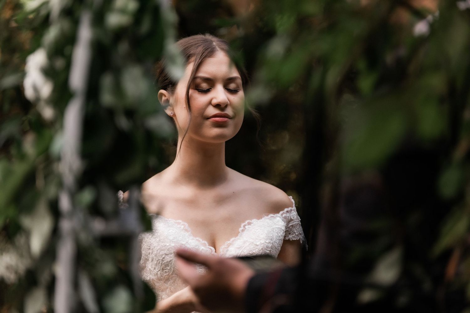 A serene moment during an outdoor wedding ceremony with soft natural lighting.