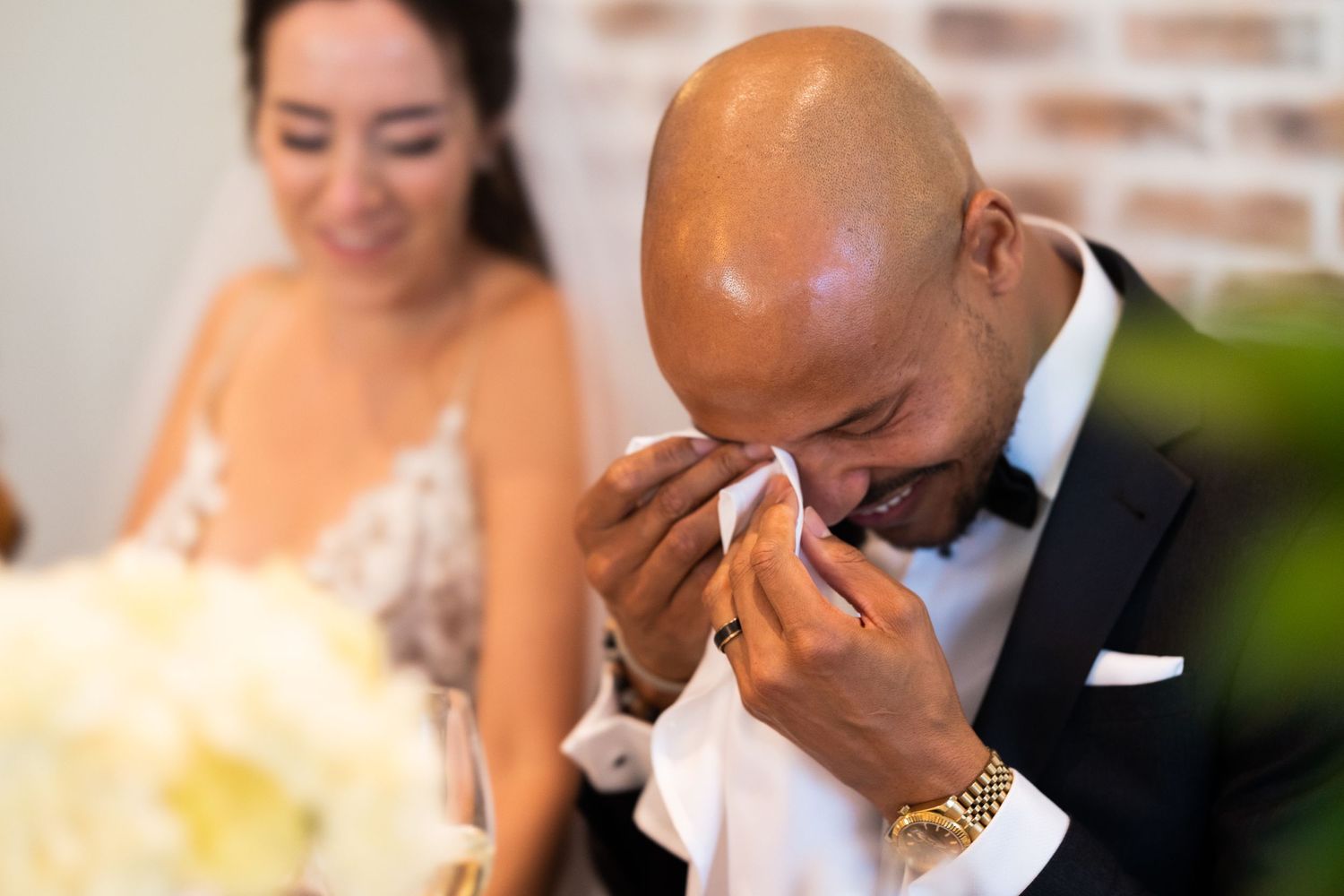 An emotional moment captured during wedding reception speeches and toasts.