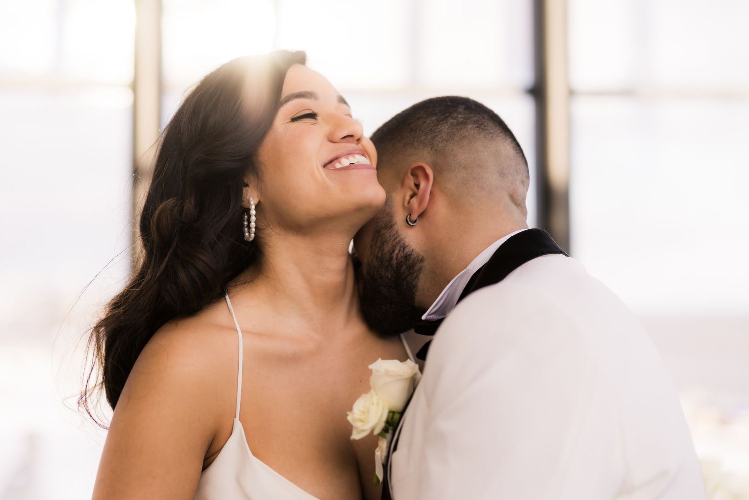 A romantic wedding photo shows a tender moment between the newlyweds.