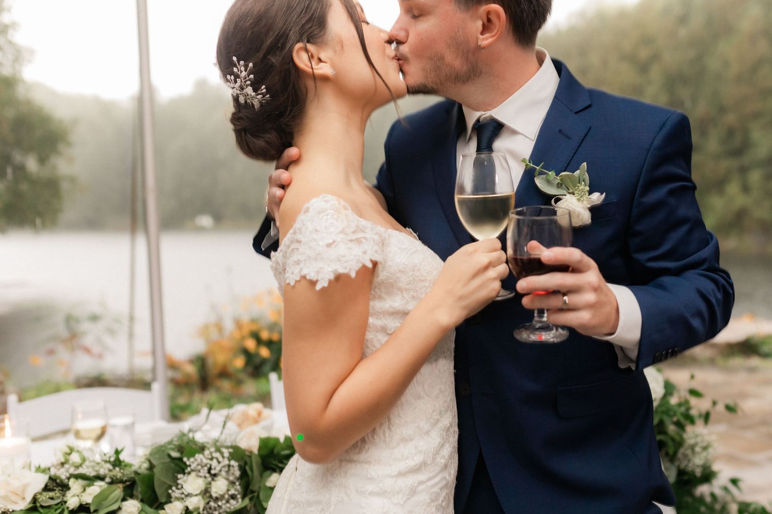 An intimate wedding moment captured during an outdoor lakeside celebration.
