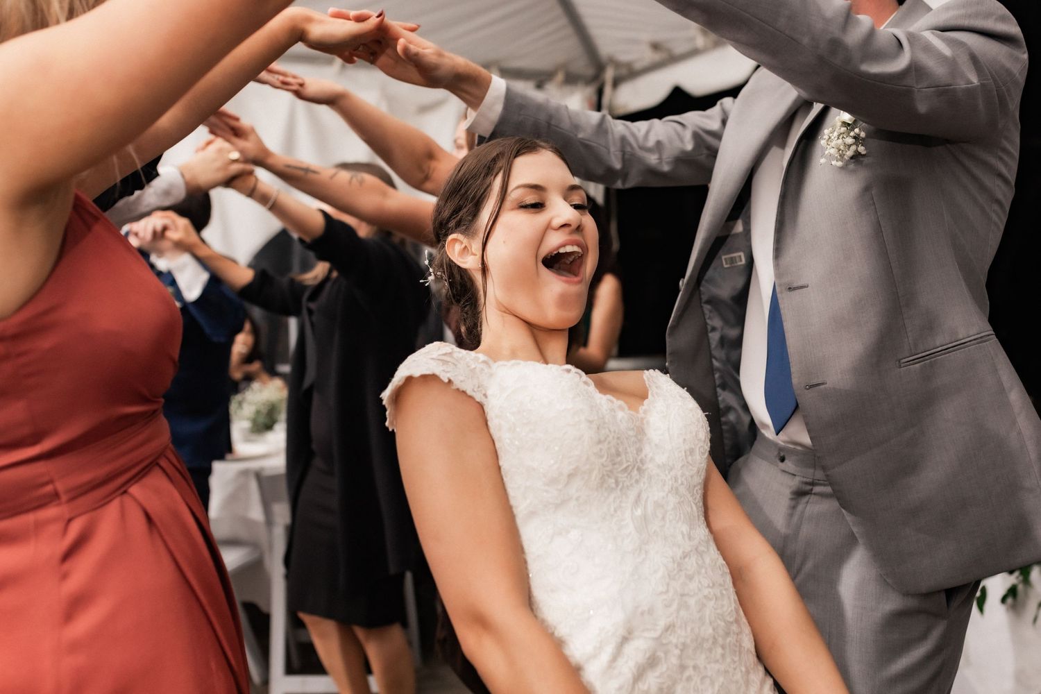 Dancing and celebration at wedding reception with joyful movement captured.