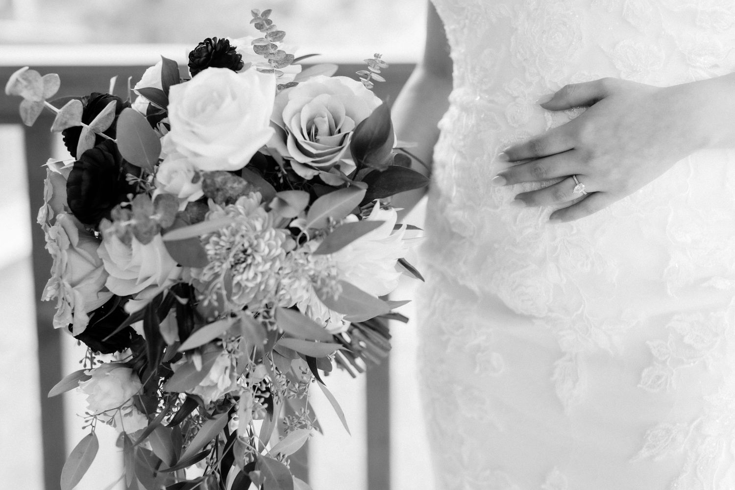 Black and white photo of a wedding bouquet with roses and delicate floral arrangement.