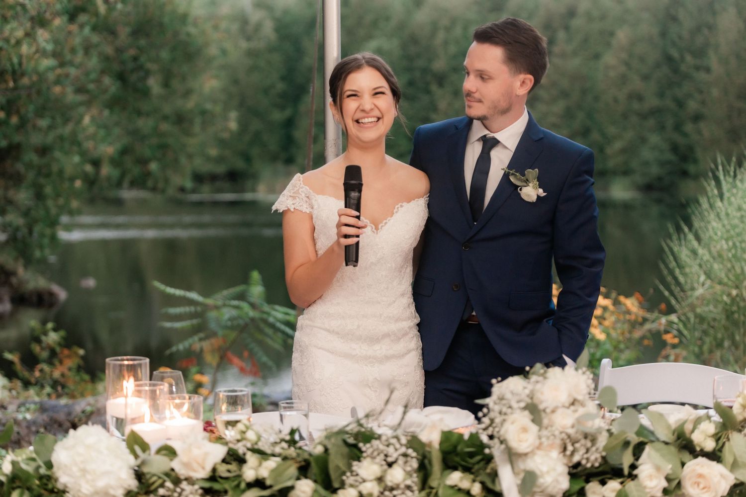 Wedding reception speech moment at elegantly decorated outdoor table setting.