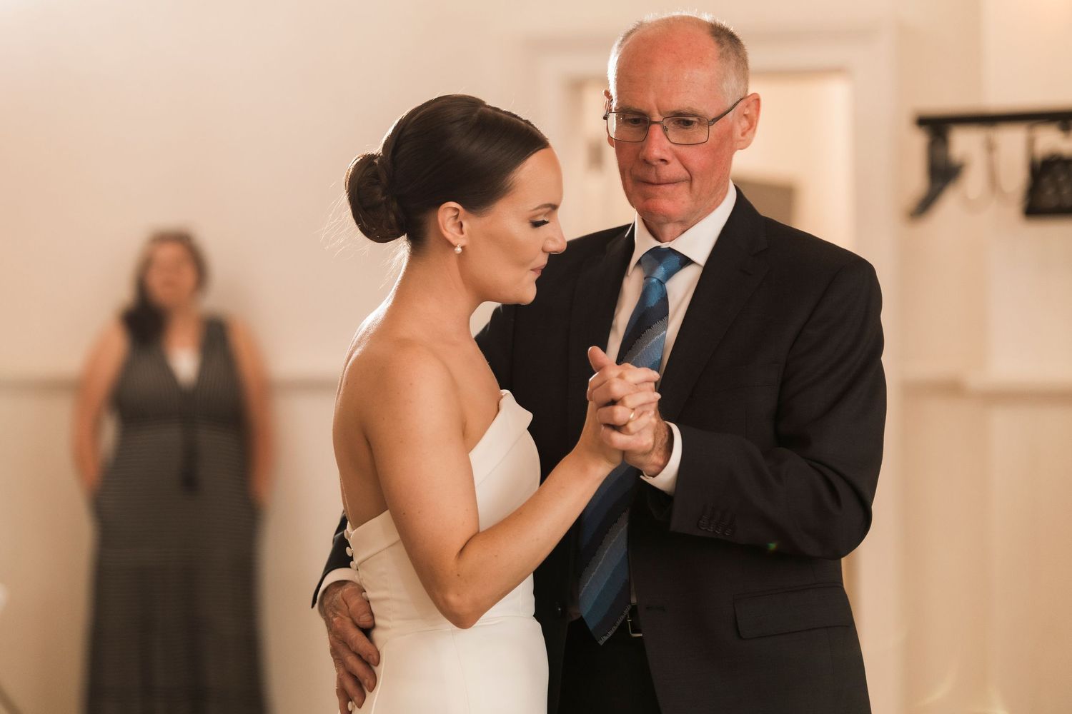 Beautiful dance moment during wedding reception in elegant bright indoor venue.
