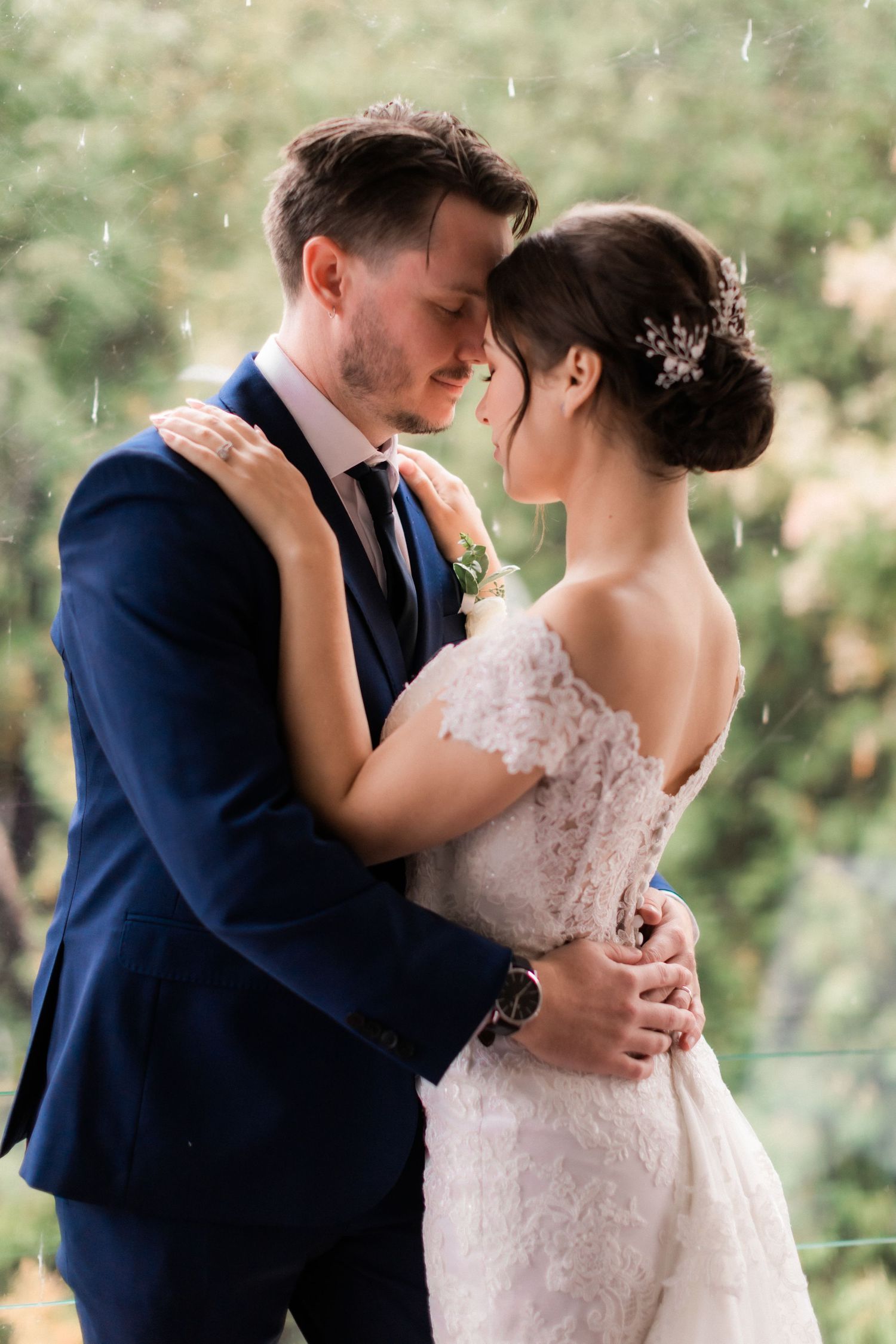 Romantic close-up of newlyweds sharing intimate moment during outdoor portrait session.