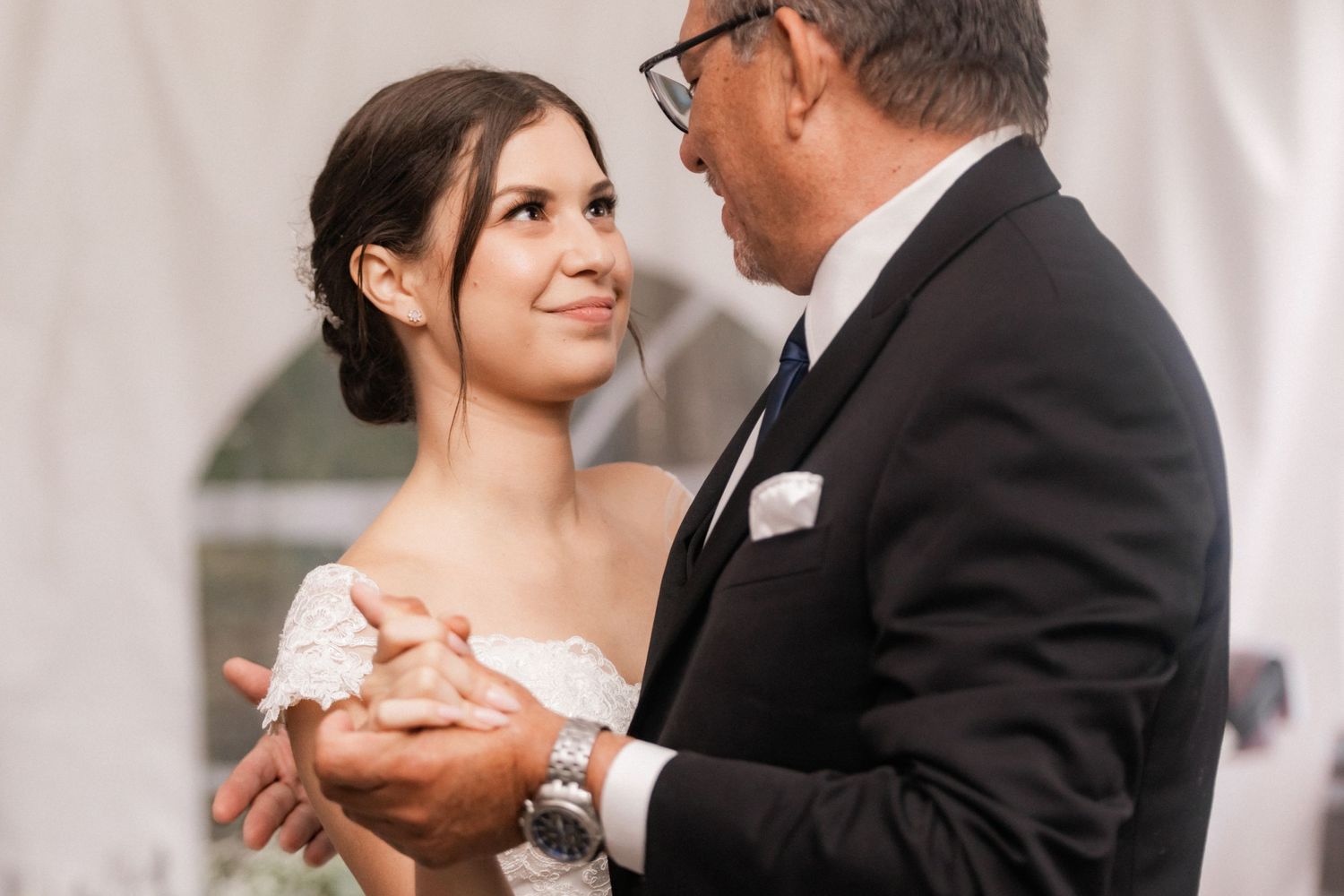 Tender dance moment captured during indoor wedding reception.
