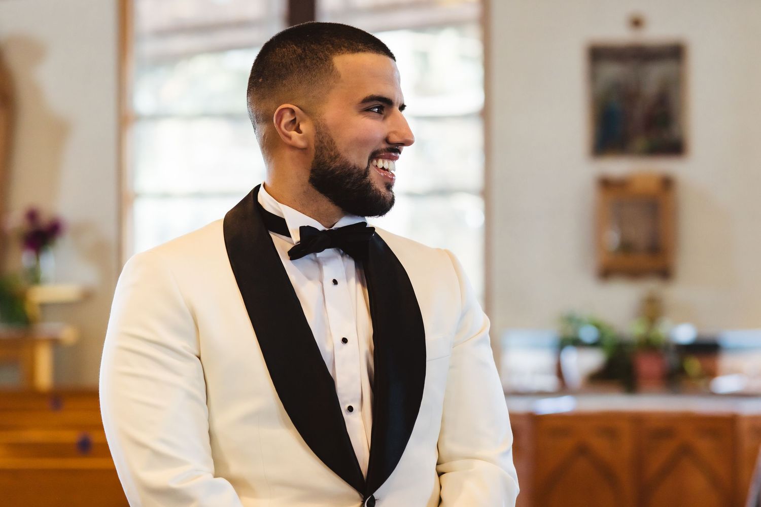 A formal wedding attire featuring a white dinner jacket with black lapels and bow tie.