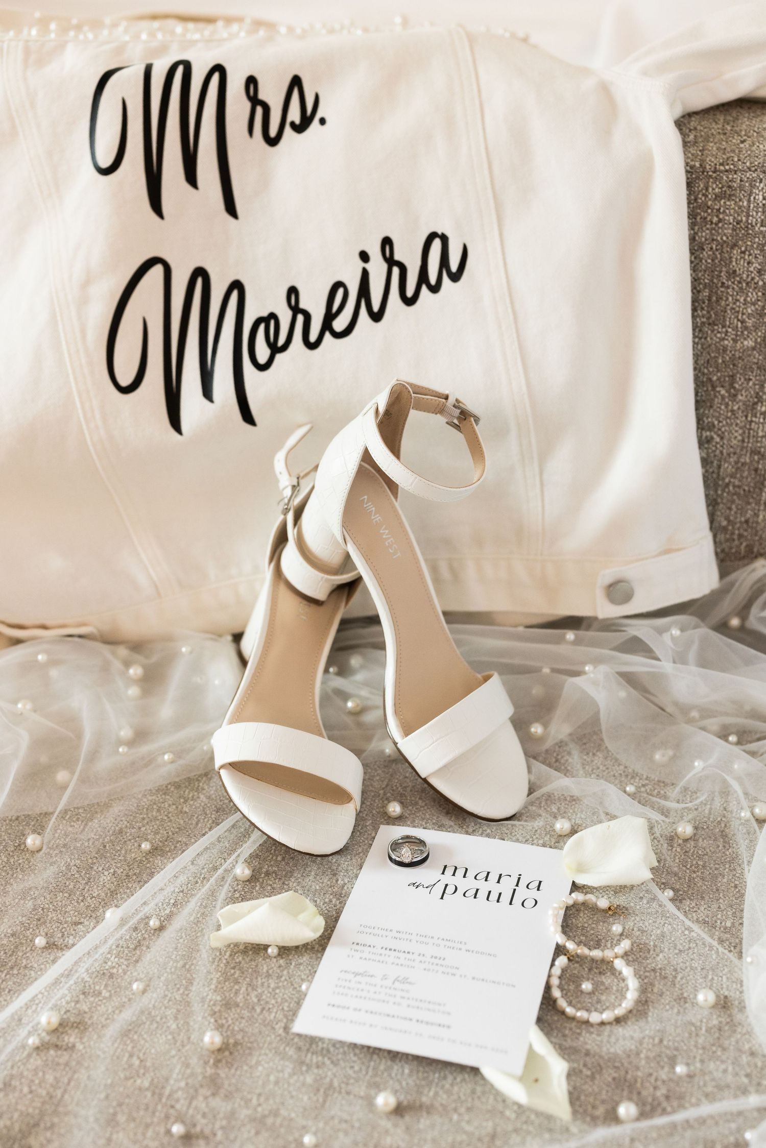 Mrs Moreira customized jacket with white heels and wedding invitation.