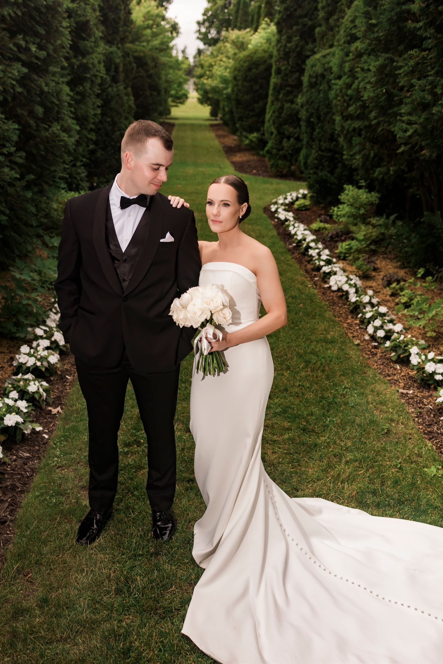 A romantic garden wedding photoshoot with a dramatic white dress train.