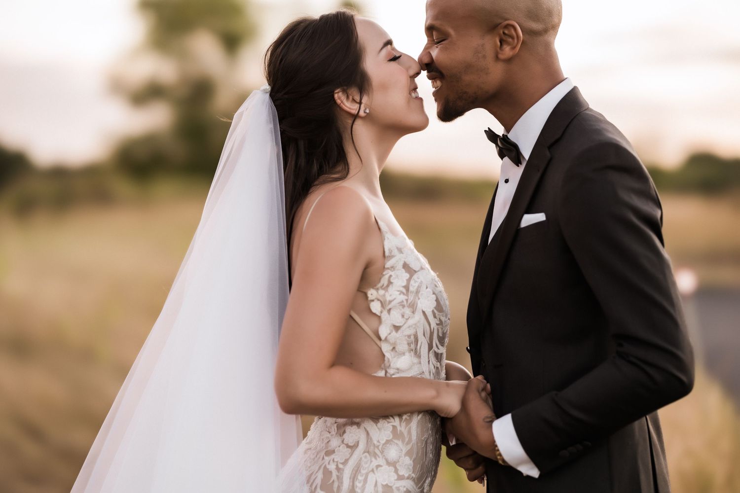 Close-up wedding portrait showing couple's loving connection in natural outdoor setting.