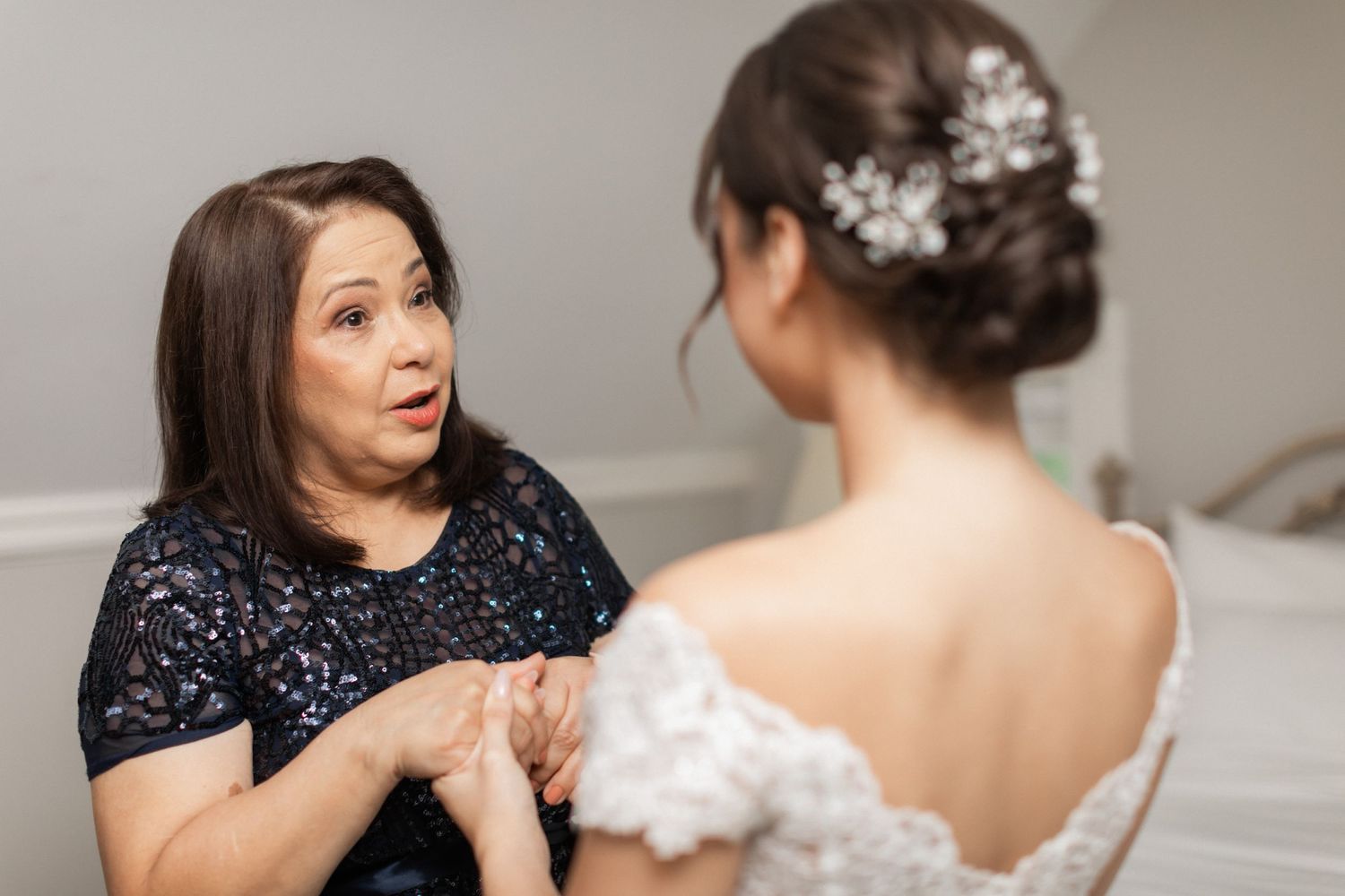 An emotional pre-wedding moment shared in a light-filled room.