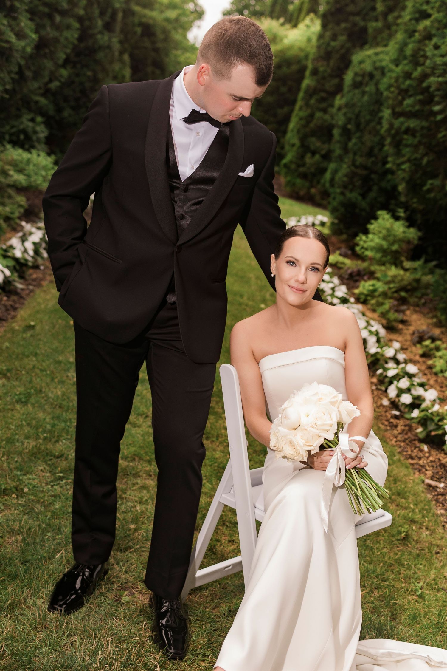 Elegant wedding photography in a lush garden setting with white floral borders.
