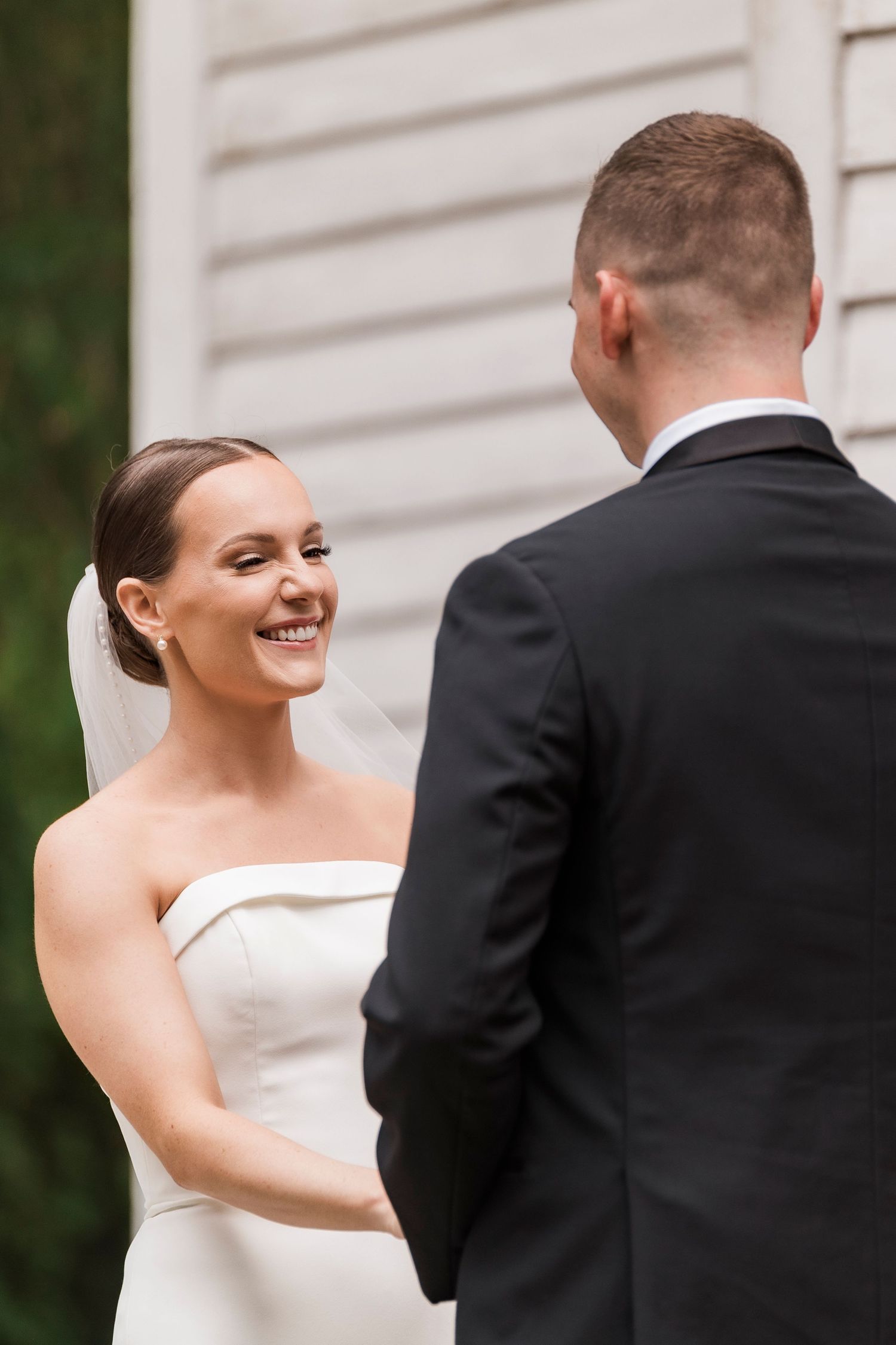A romantic first look sequence shows a bride surprising her groom in an elegant outdoor setting.
