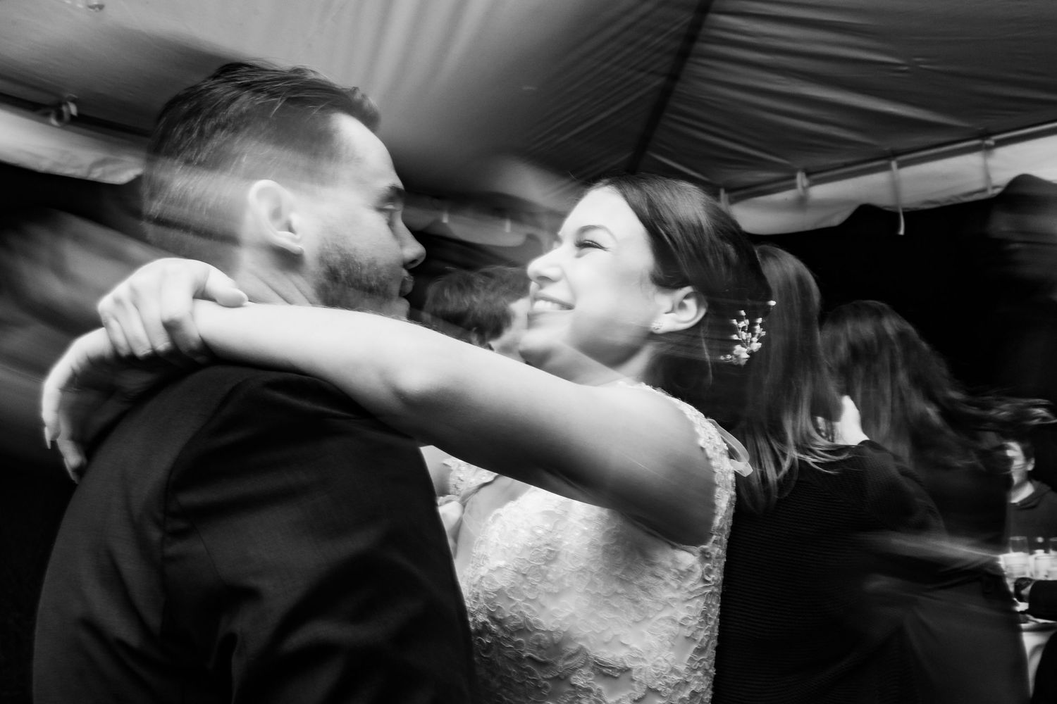 A black and white candid dancing moment captured during the wedding reception.