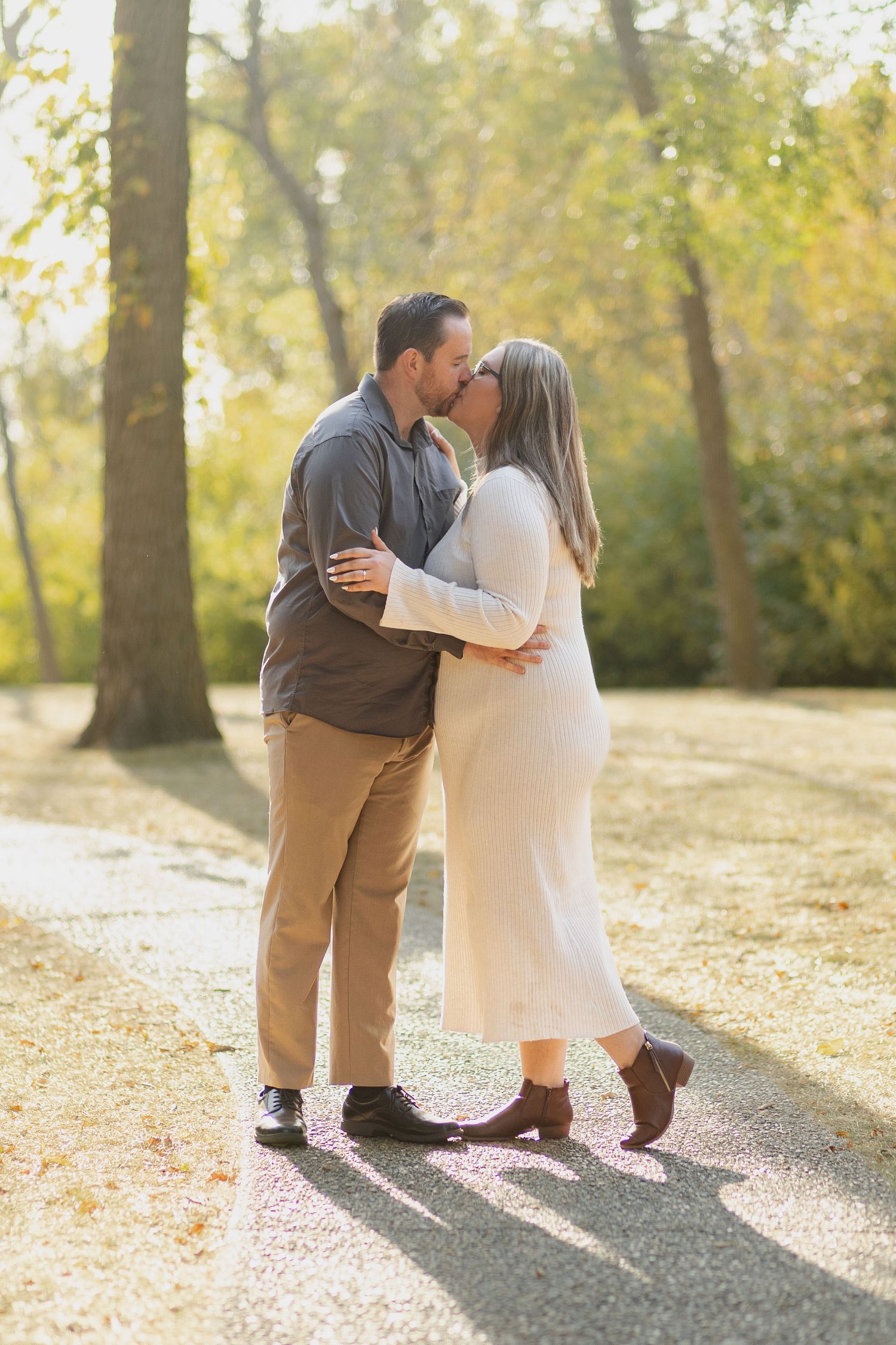A couple sharing an intimate moment in golden autumn sunlight.