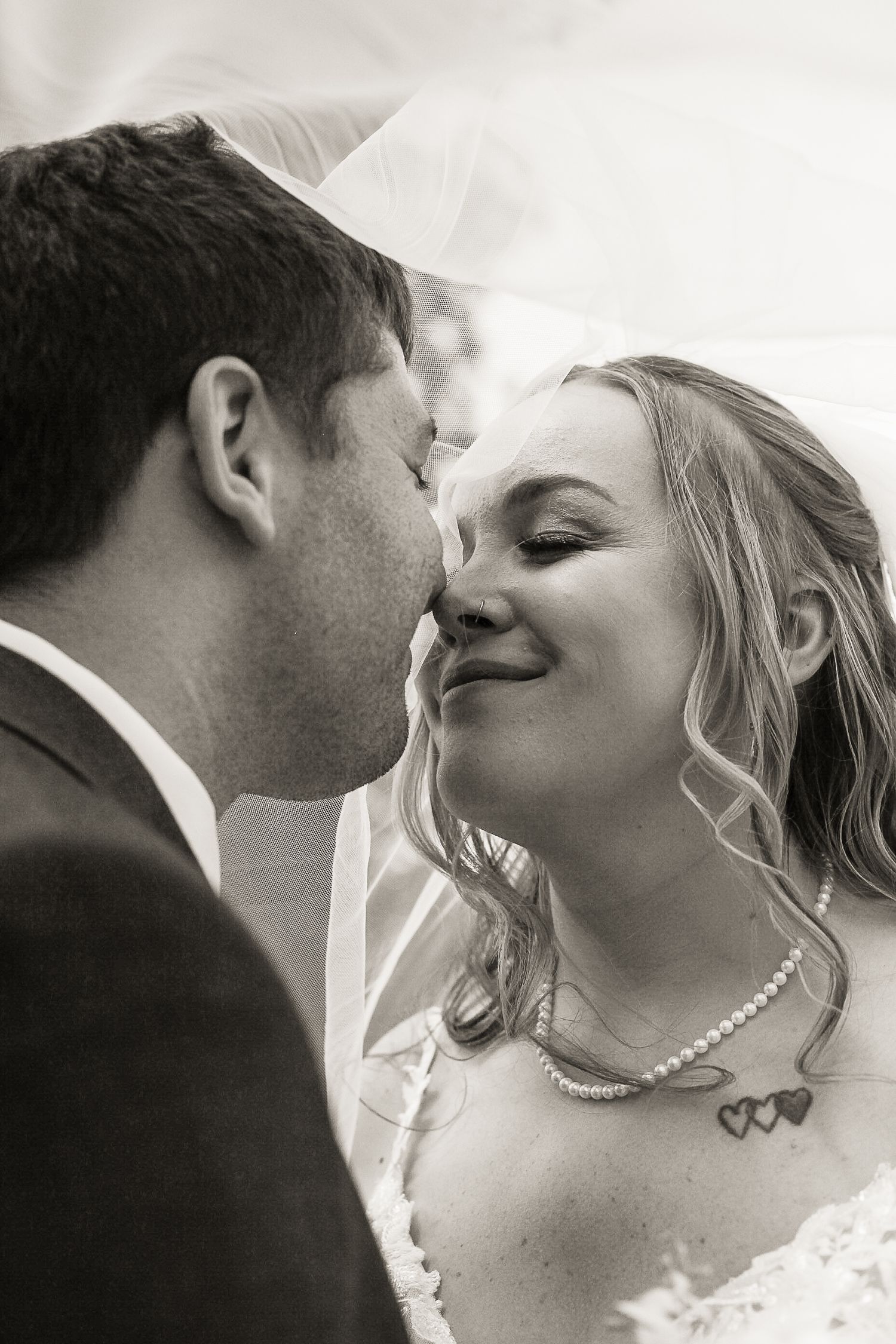 Black and white close-up of newlyweds sharing an intimate moment.