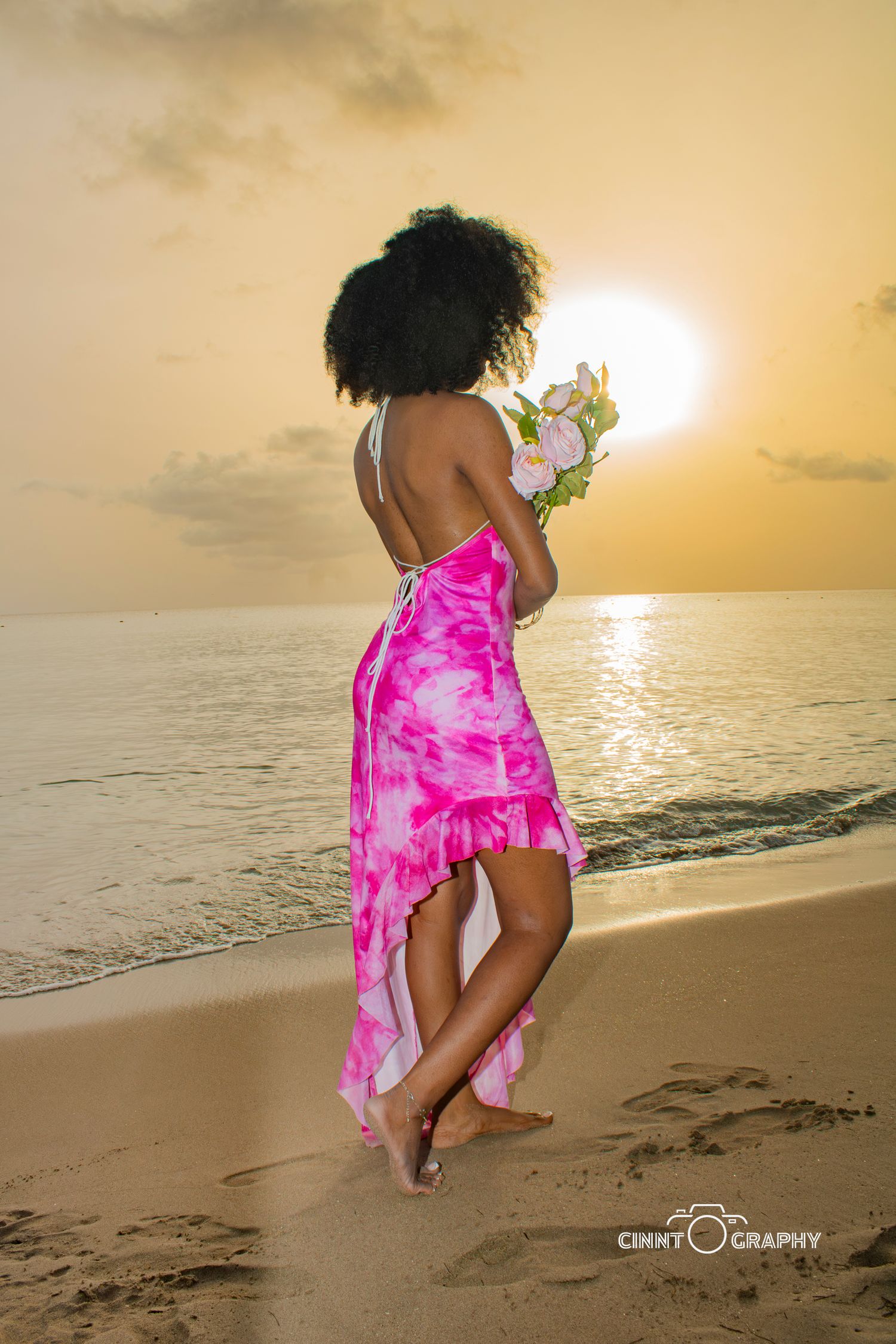 A series of beach silhouettes at sunset shows someone in a pink floral dress dancing and jumping on golden sand.