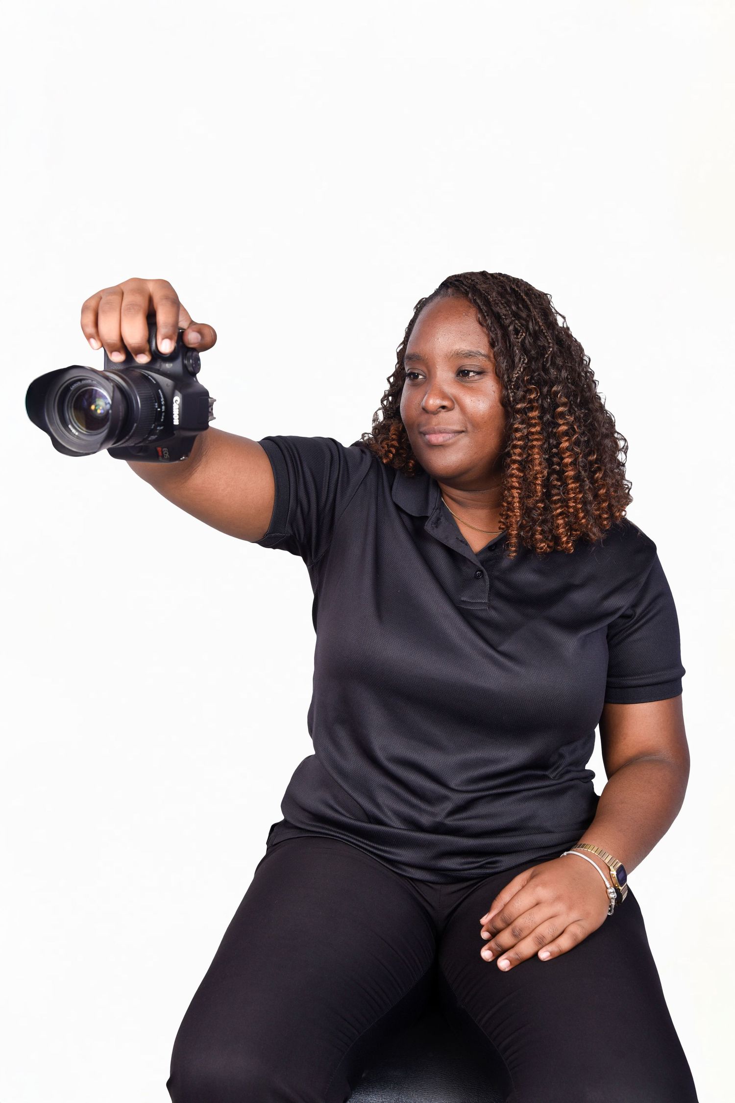 Professional photographer in black clothing demonstrates various posing positions against a white background.