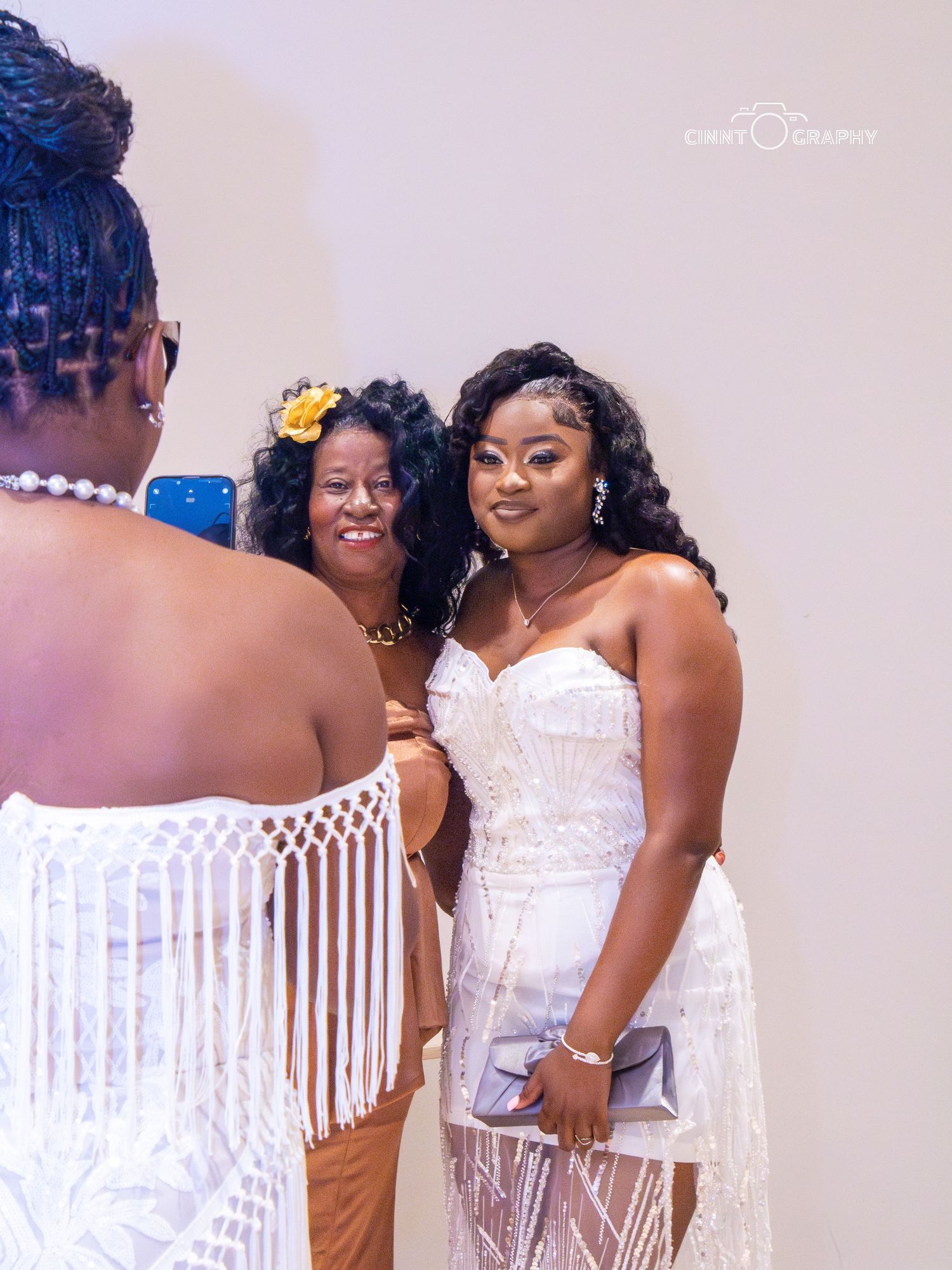 A series of joyful wedding party photos showing friends in matching white dresses at a celebration.