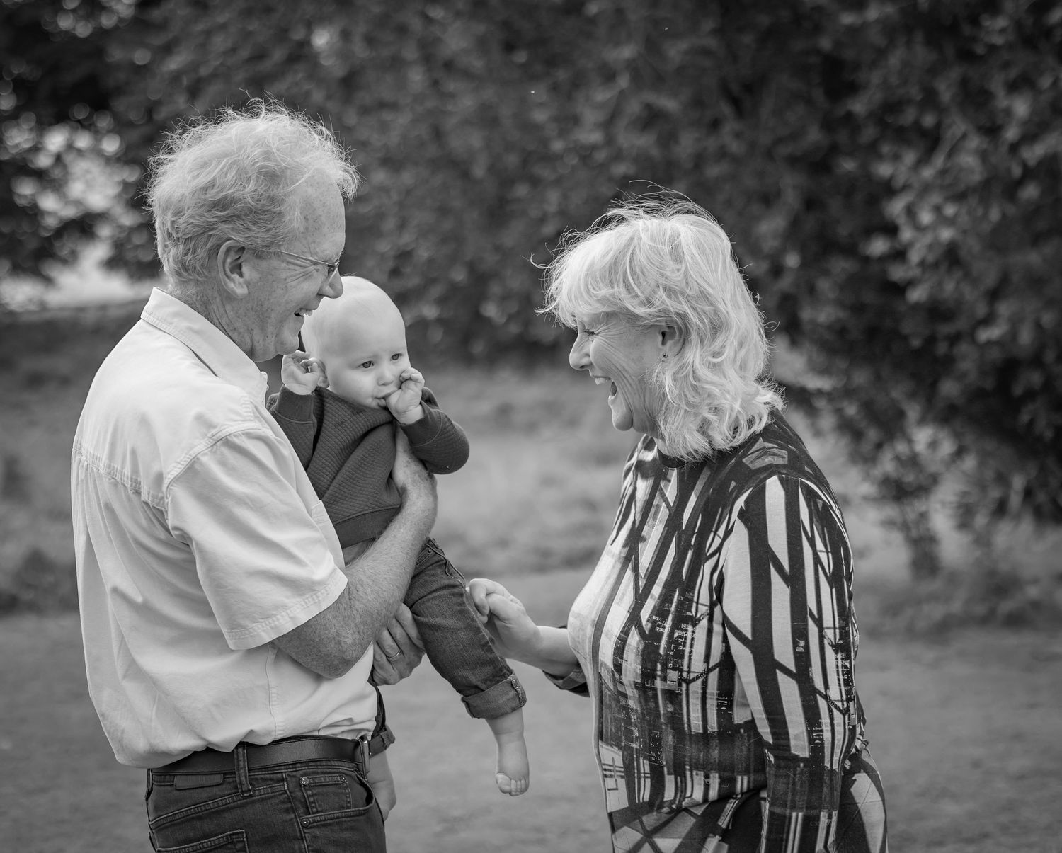 A series of candid black and white photos showing playful interactions outdoors.