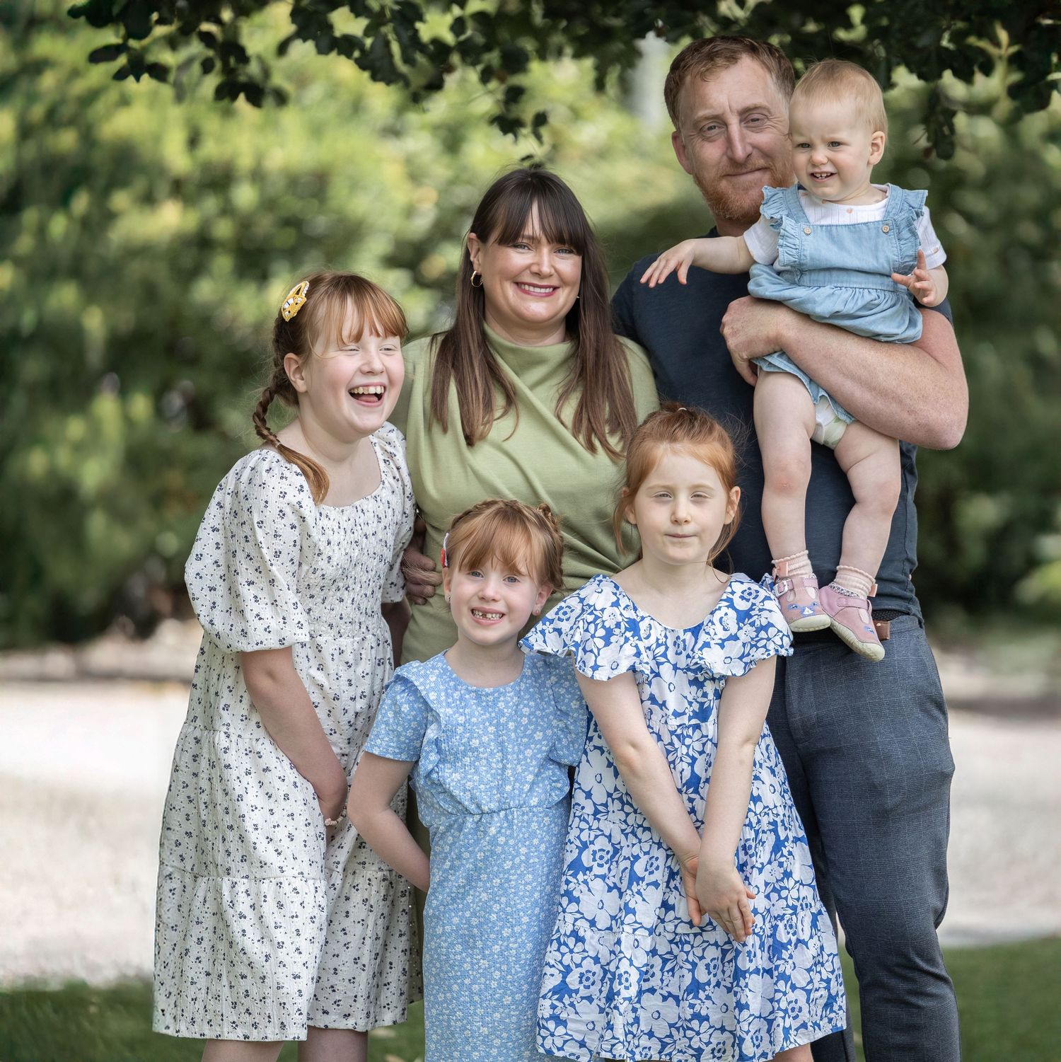 A group photo sequence outdoors showing children in floral dresses among green foliage.