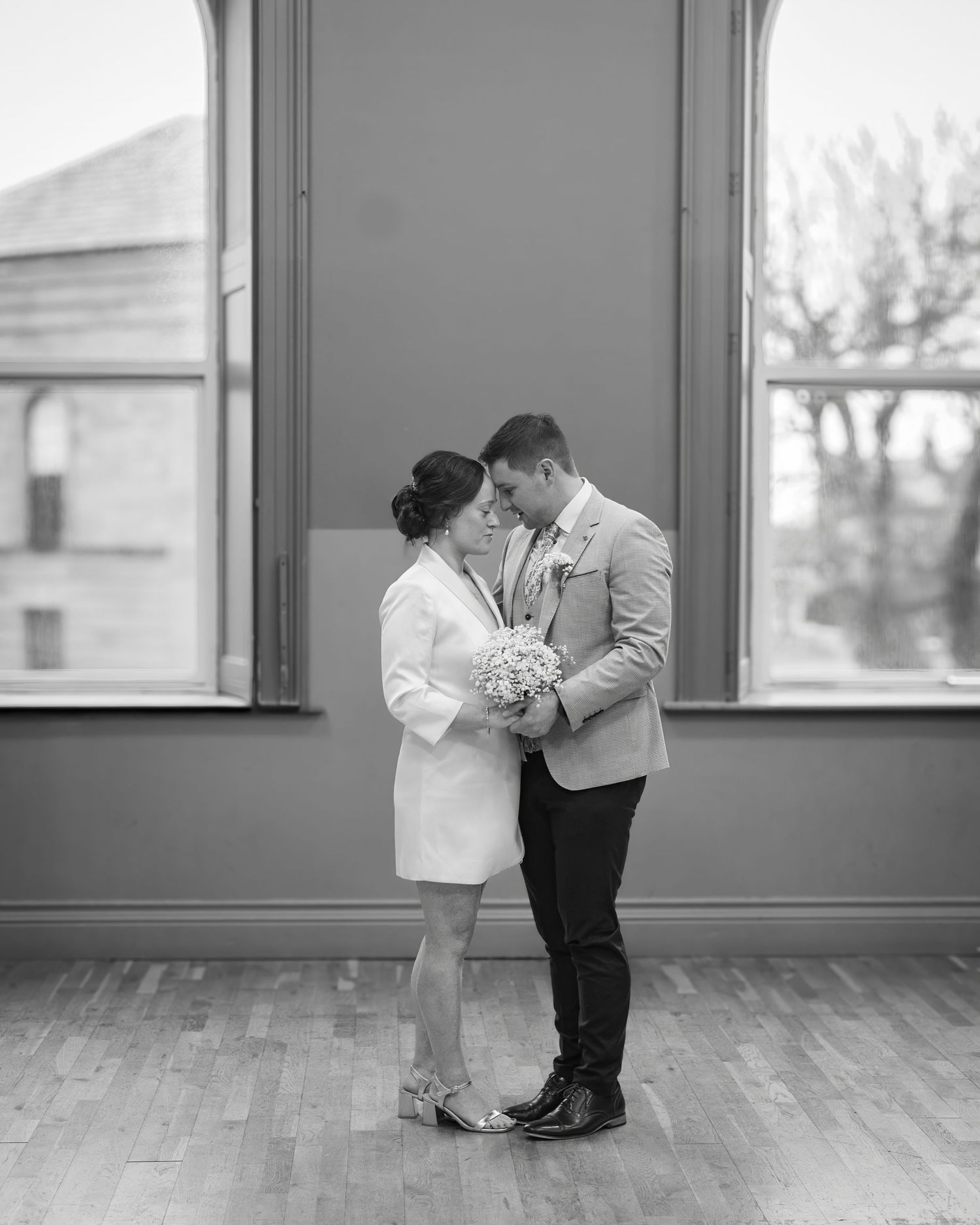 A romantic black and white photo sequence shows a couple dancing together in an empty sunlit room.