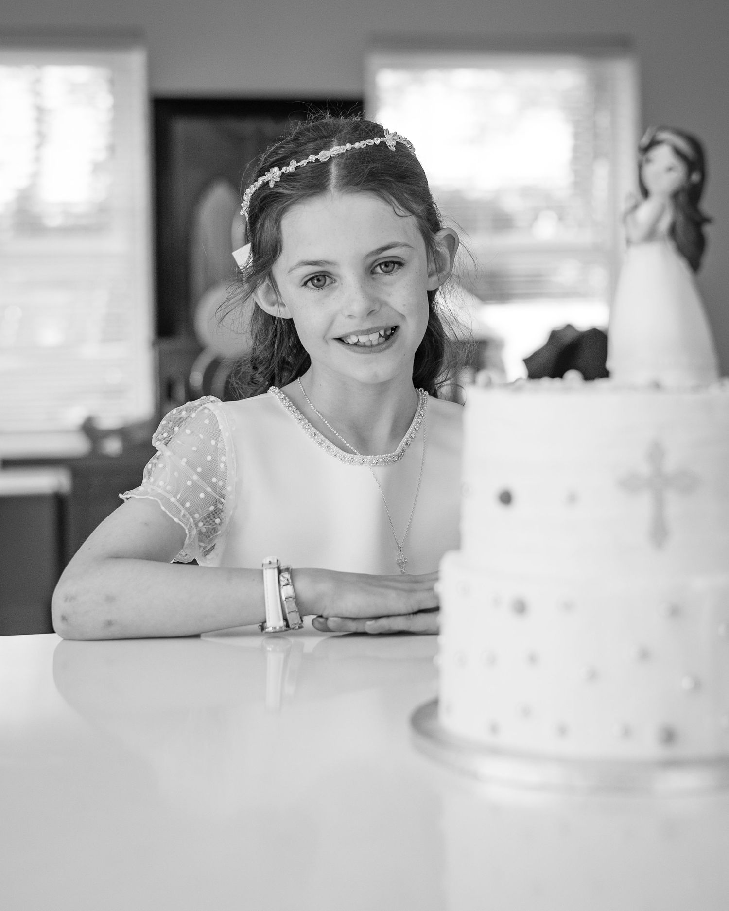 Black and white photos capturing sweet moments with a decorated celebration cake.