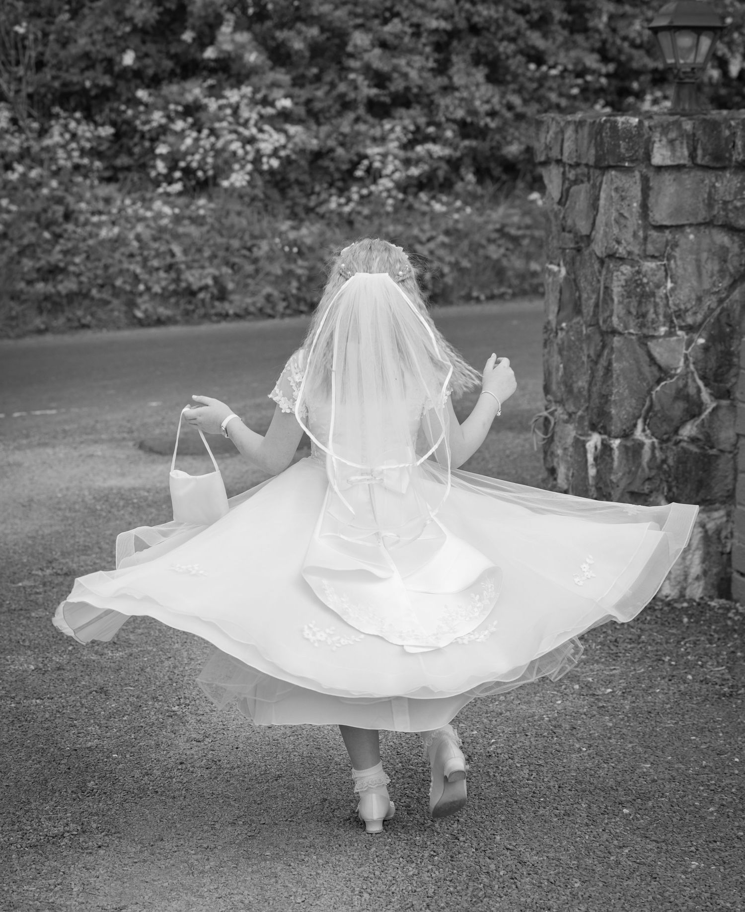Series of black and white photos showing flowing white dress movement on grass.