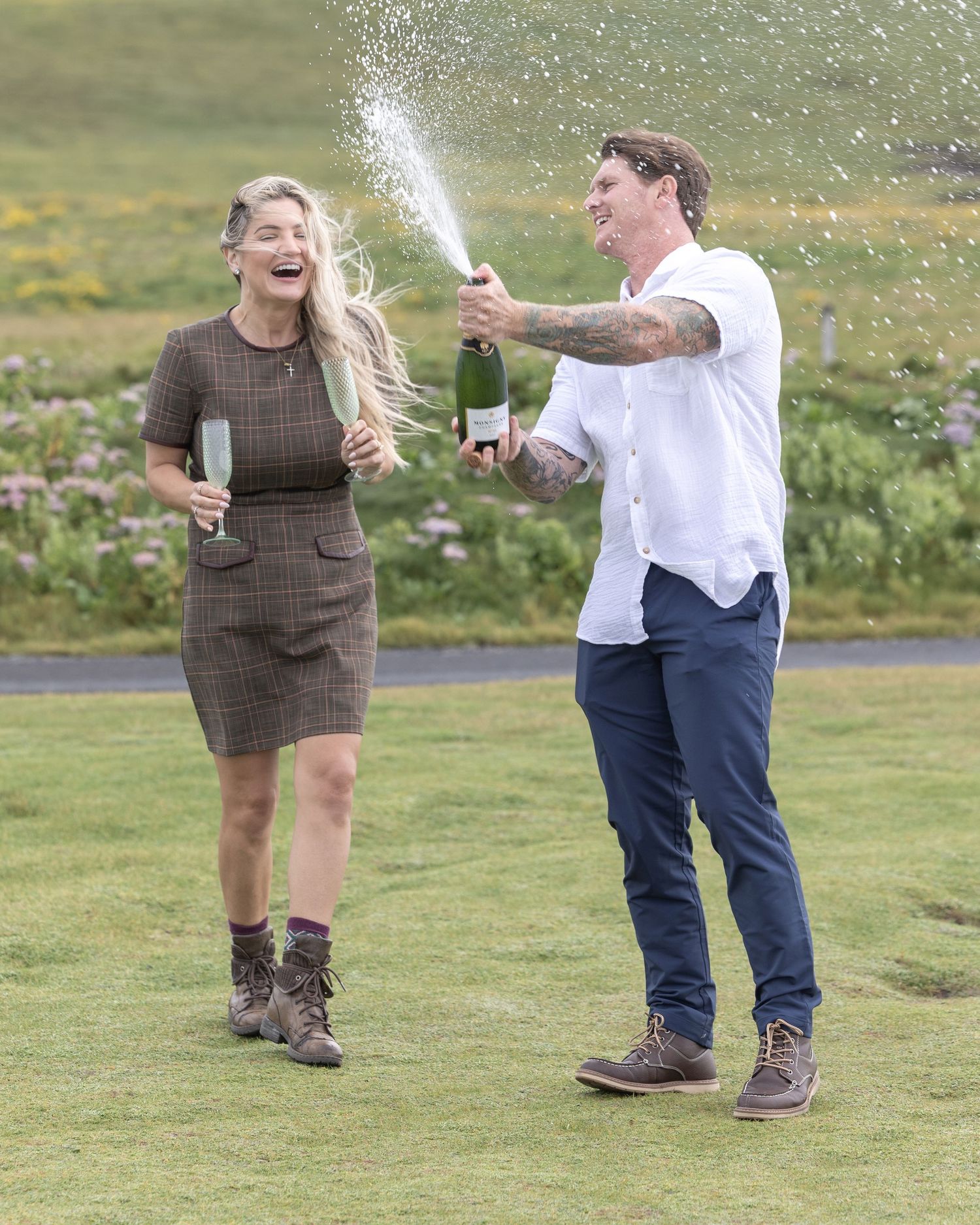 Sequence showing couple spraying champagne and celebrating outdoors.