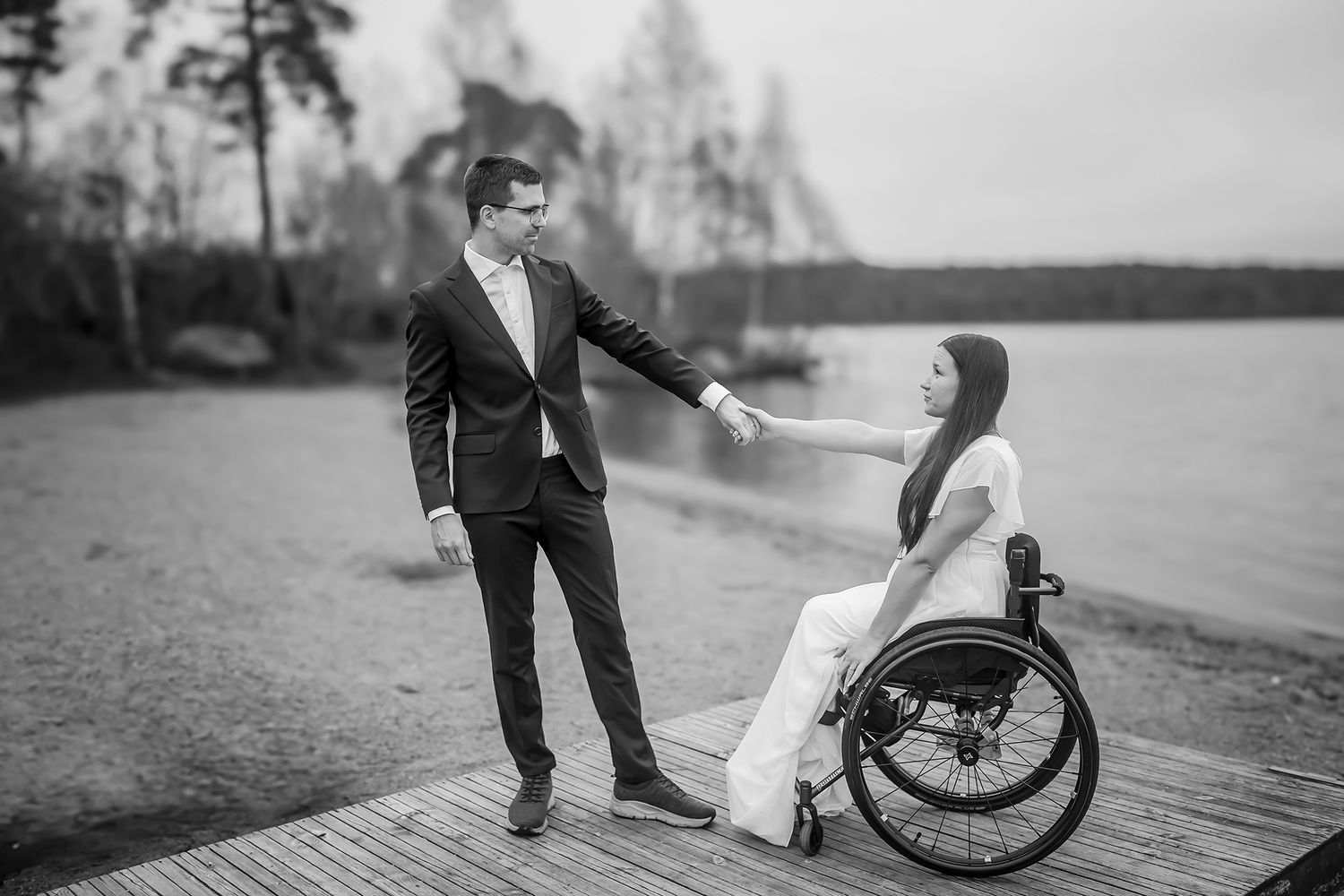 A collection of black and white wedding photos showing romantic moments by a scenic lakeside path.