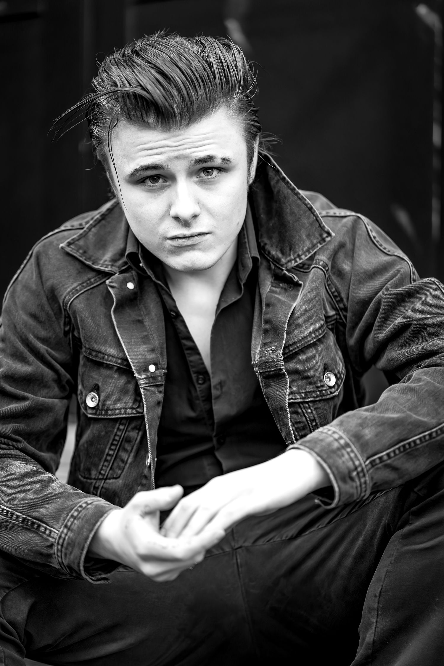 Classic black and white portrait of a person in denim jacket with retro styling.