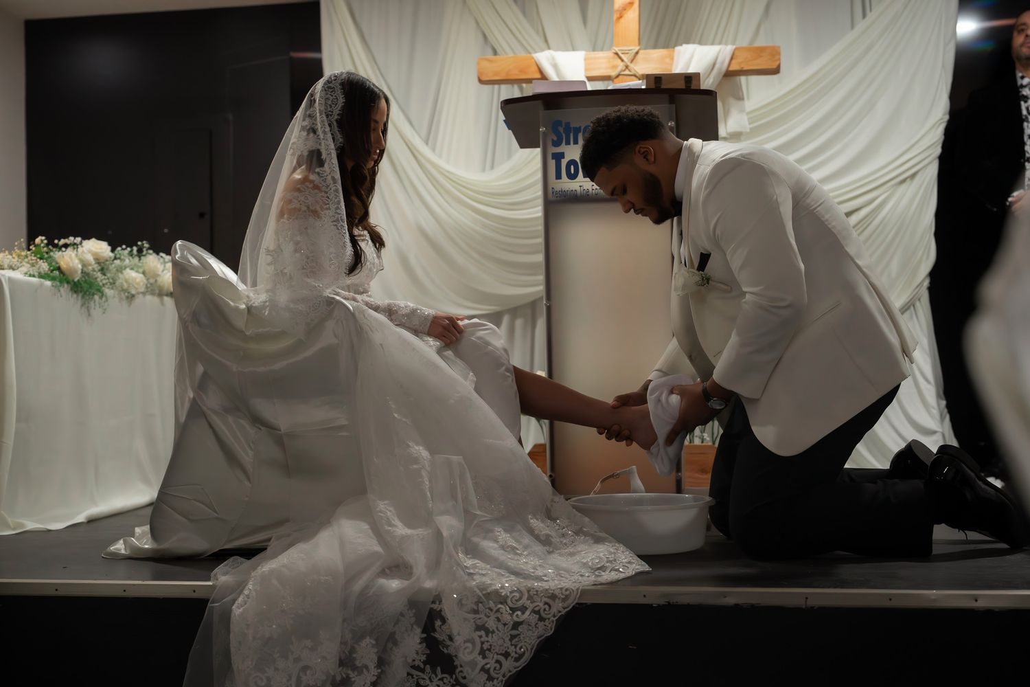 A series of photos showing a wedding dress being carefully prepared and fitted in a bridal salon.